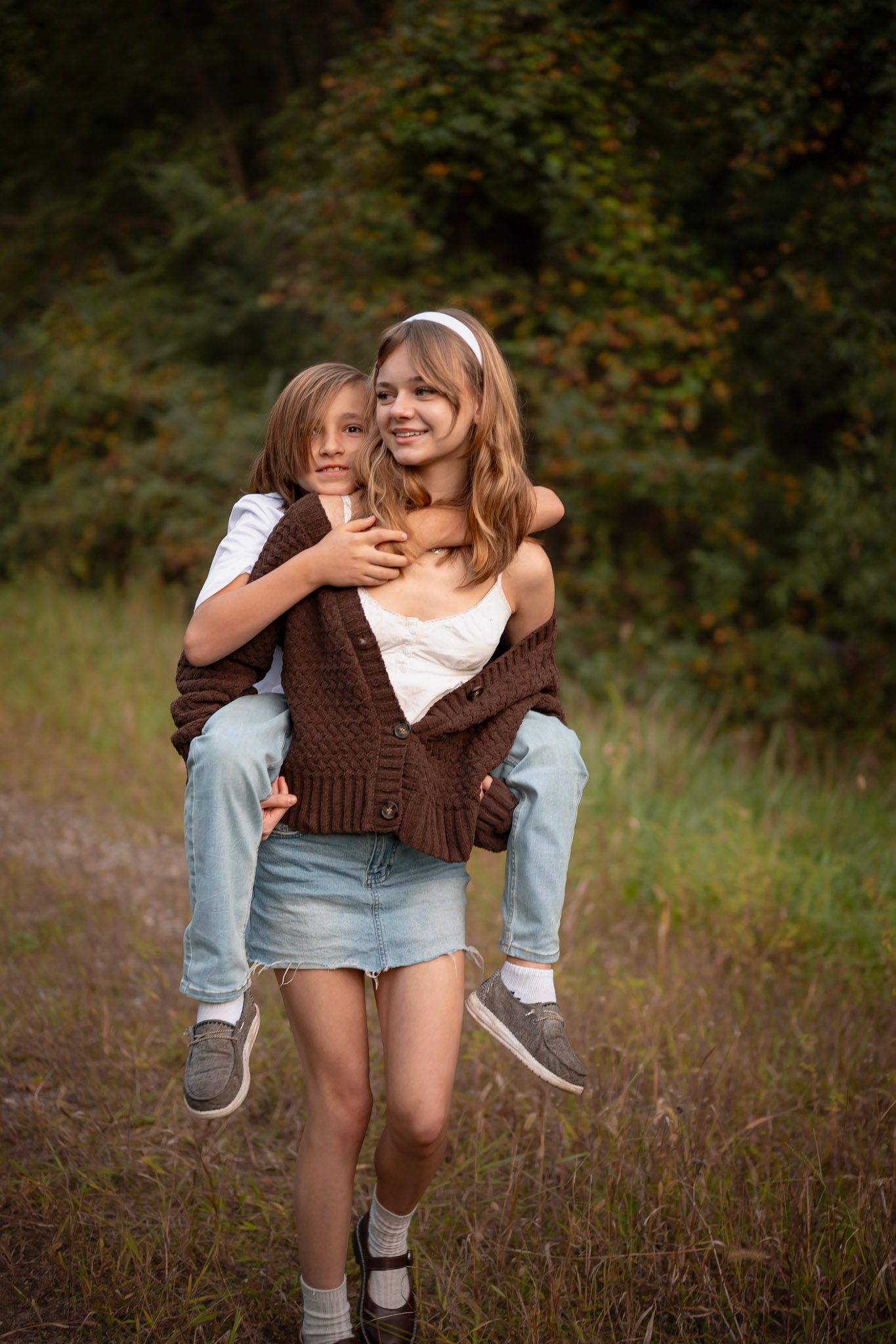 Sister and brother playing in tall grass, Chesapeake VA family photographer.