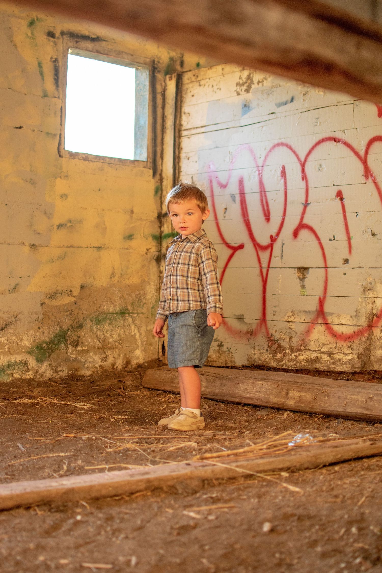 Little boy posing in rustic abandoned building, Chesapeake VA urban portrait photographer.