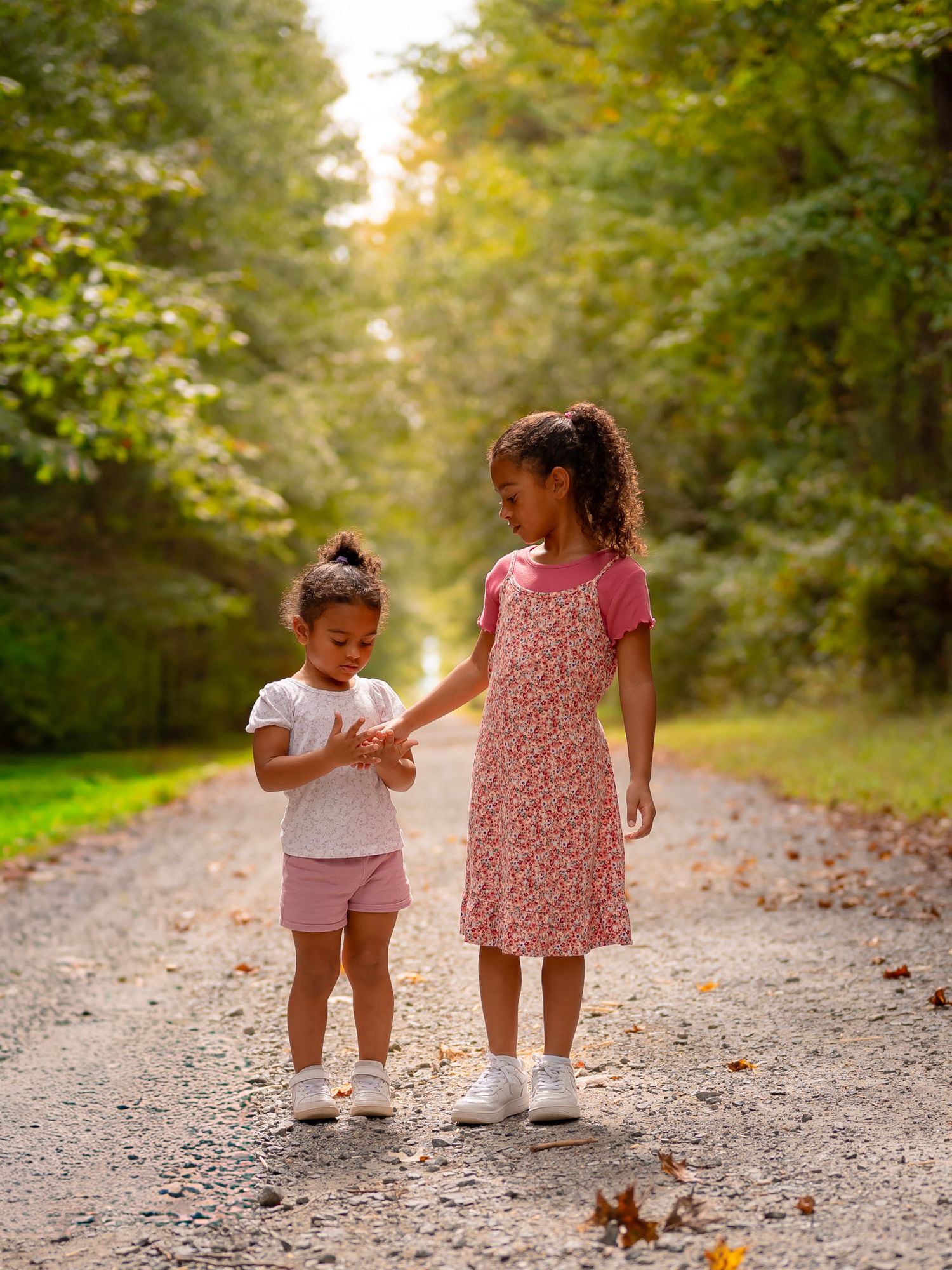 Siblings holding hands in fall field, Chesapeake VA outdoor family photography.