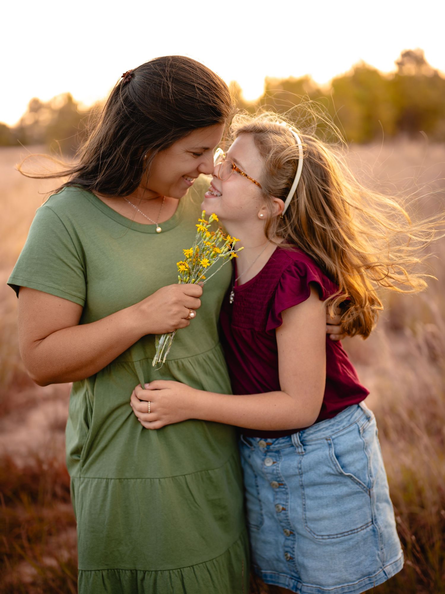 Mom in green dress sharing a sweet moment with daughter, Chesapeake VA family photographer.