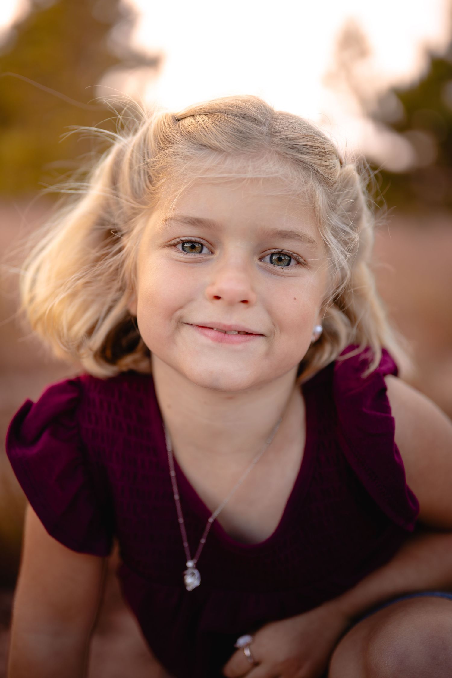 Young girl smiling during fall portrait, Chesapeake Virginia child photographer.