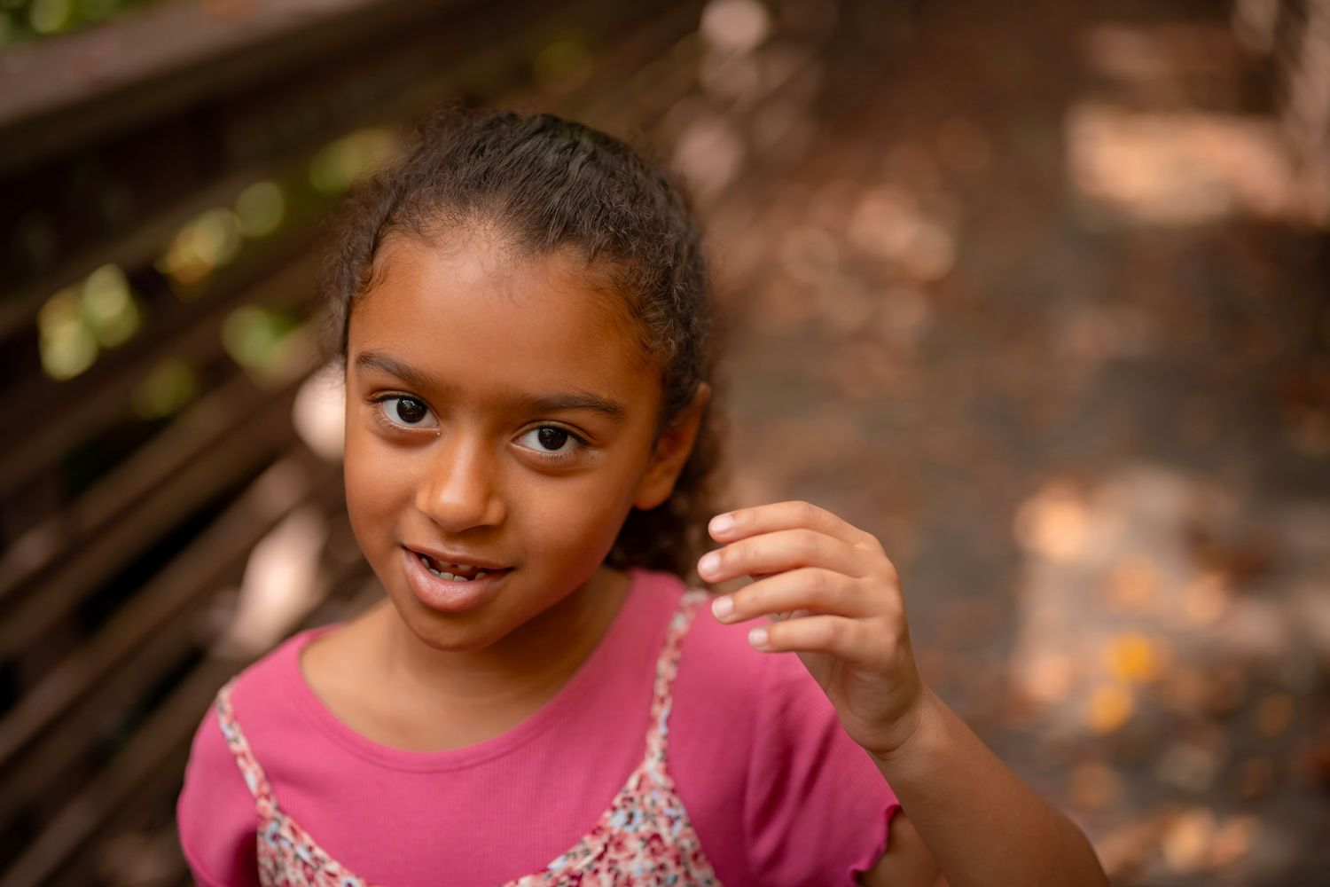 Little girl laughing in purple shirt at sunset, Chesapeake VA child photographer.