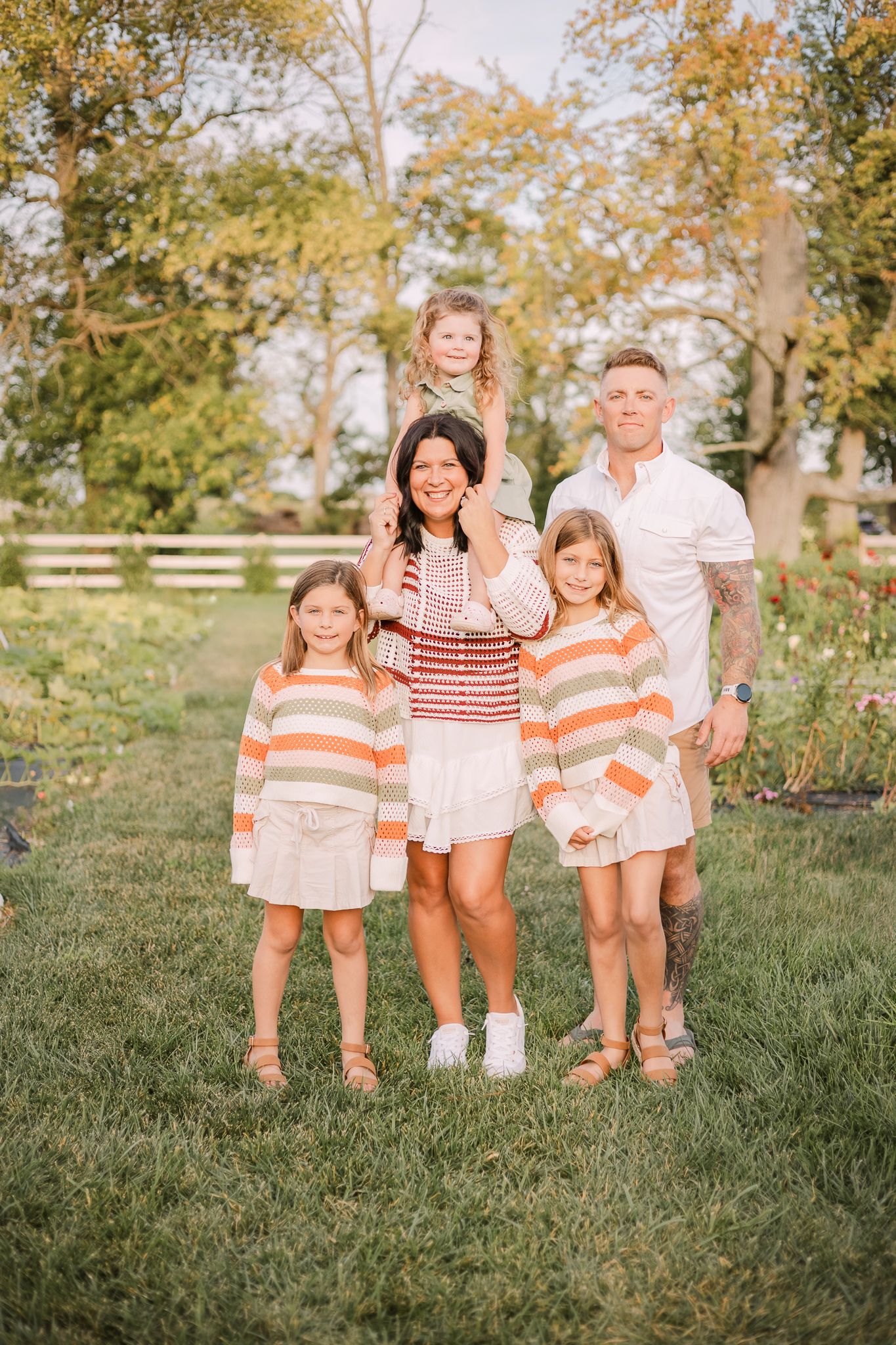 family of five at a flower farm, mom has the youngest on her shoulders in Noblesville, IN