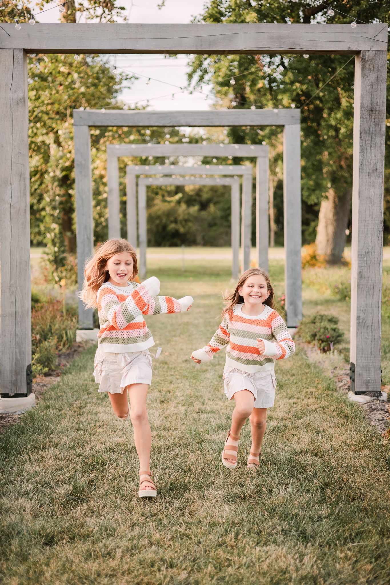 sisters running through a flower farm in Noblesville, IN