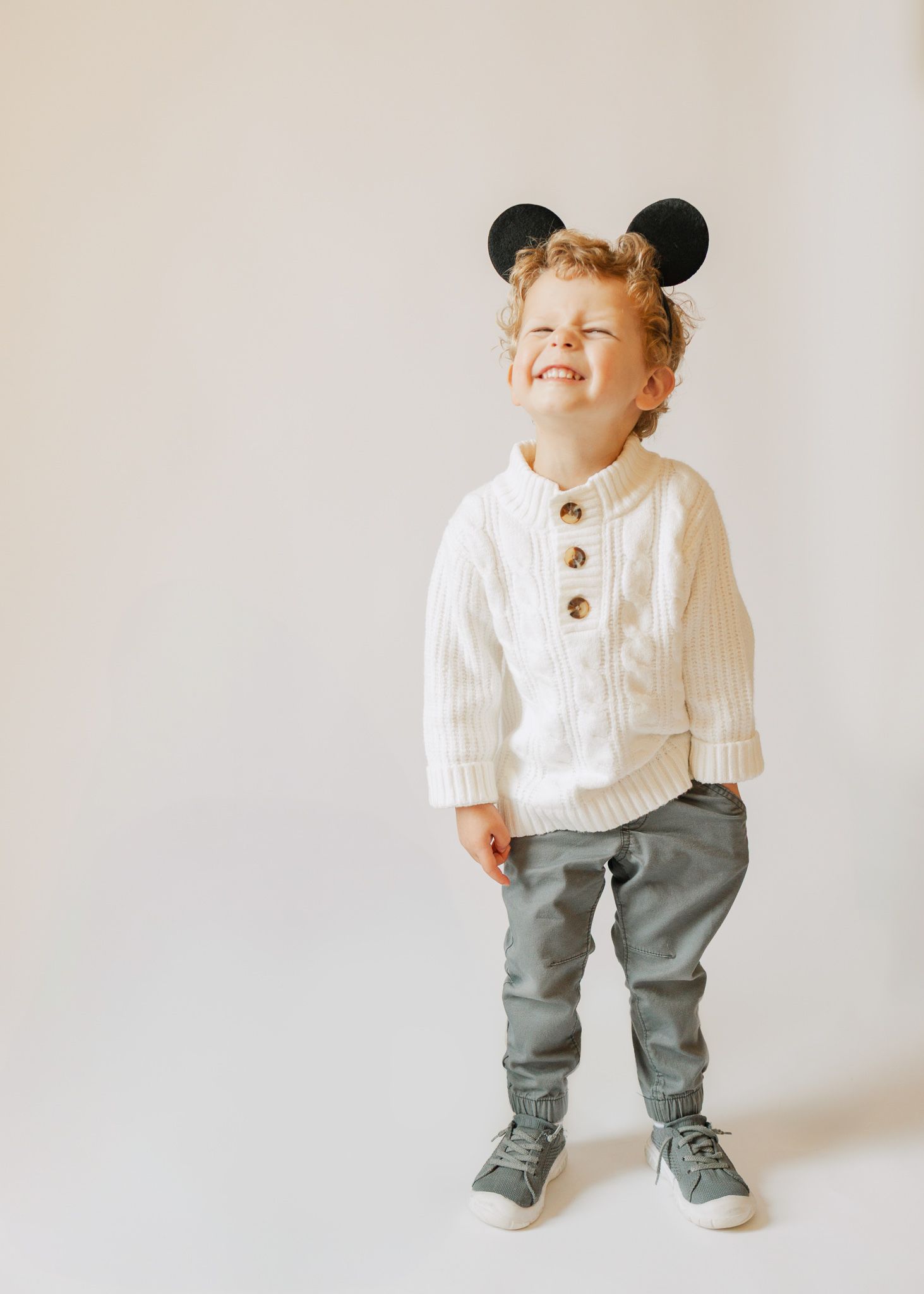 toddler wearing mickey mouse ears in studio
