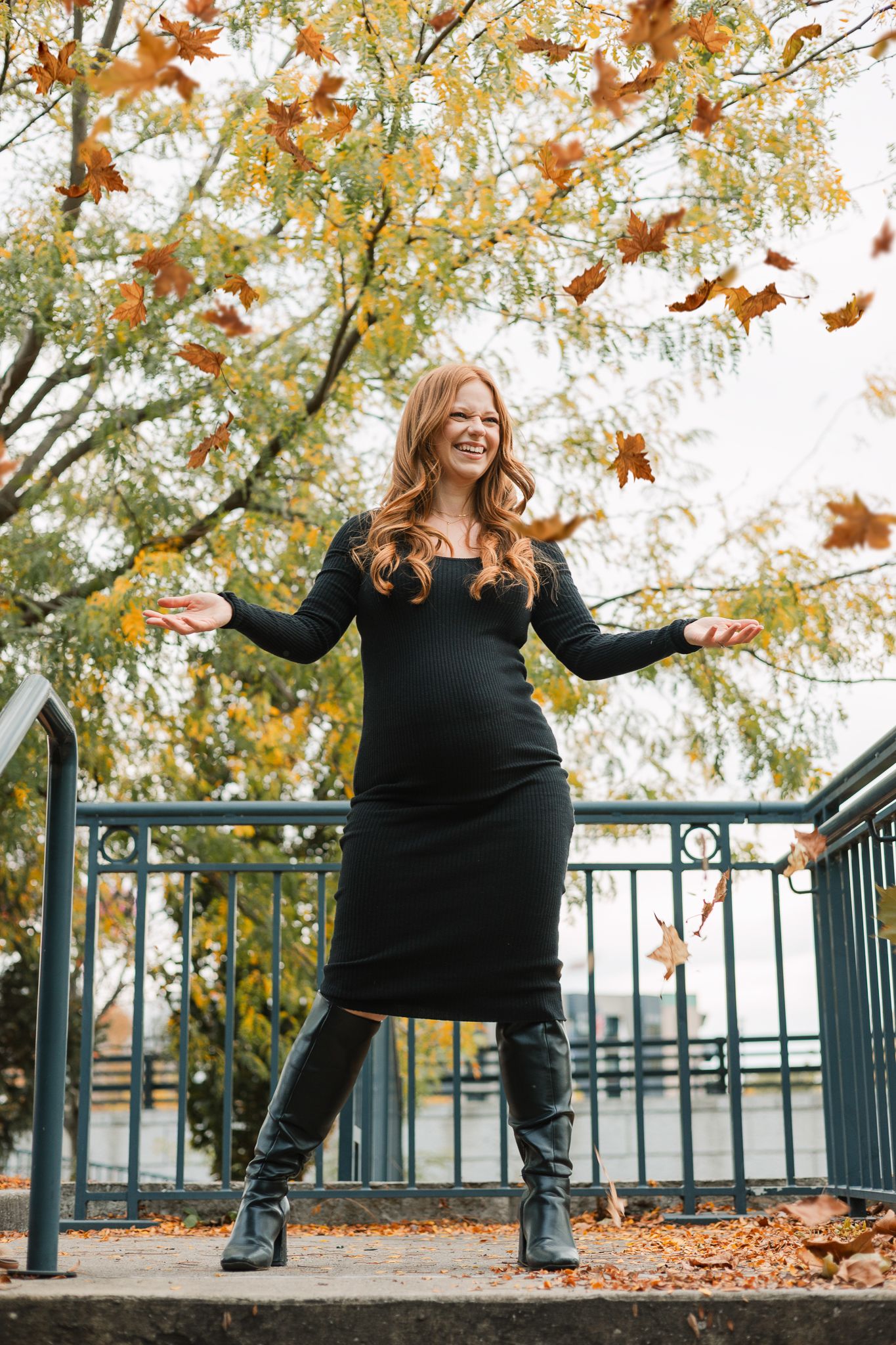 fall maternity session tossing up leaves