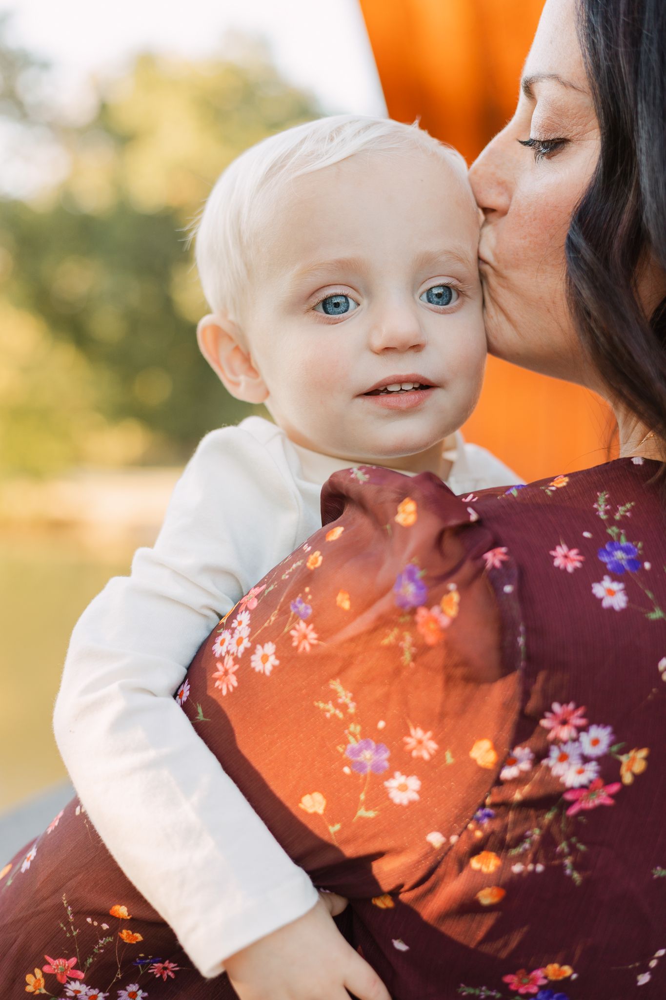 mother giving baby a kiss on the forehead in Fishers, IN