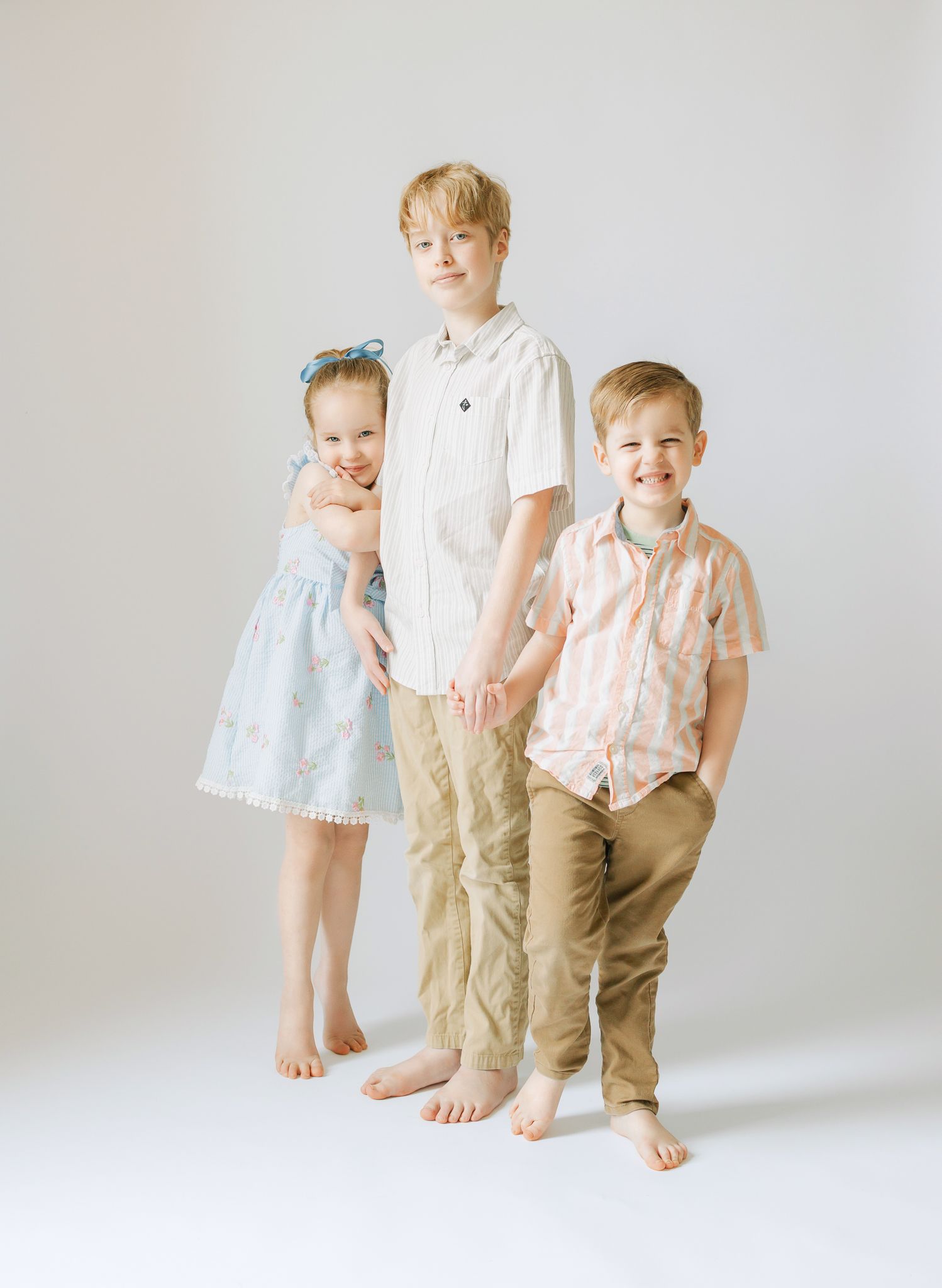 three siblings in studio setting