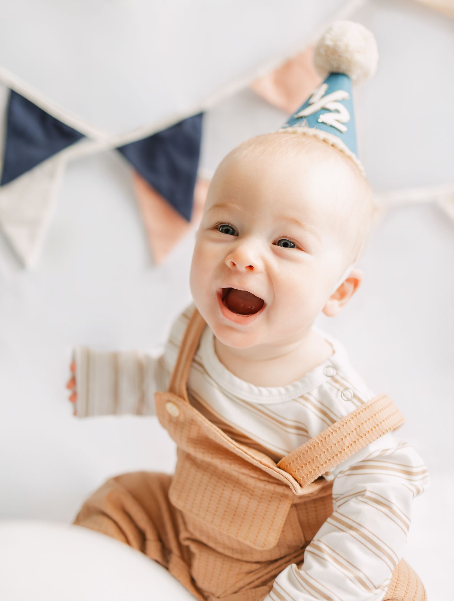 baby smiling with a banner behind