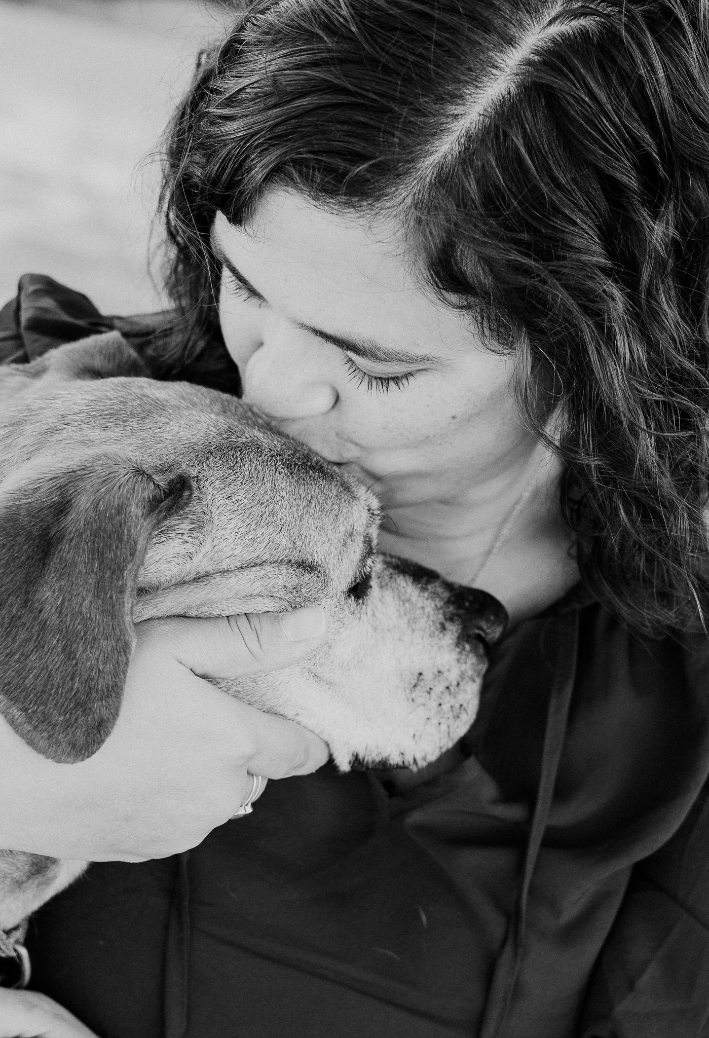 celebration of life with owner giving pup a kiss on the forehead