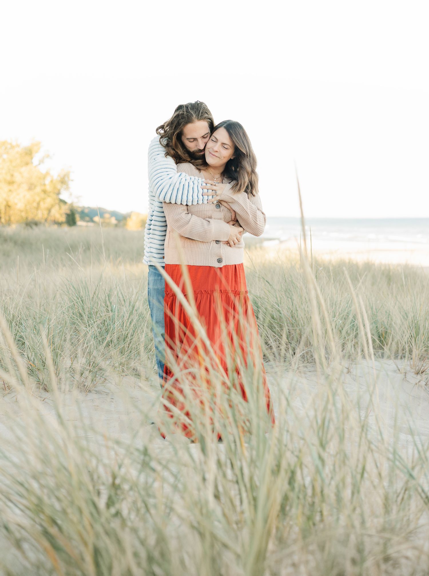 husband holding wife from behind snuggled up
