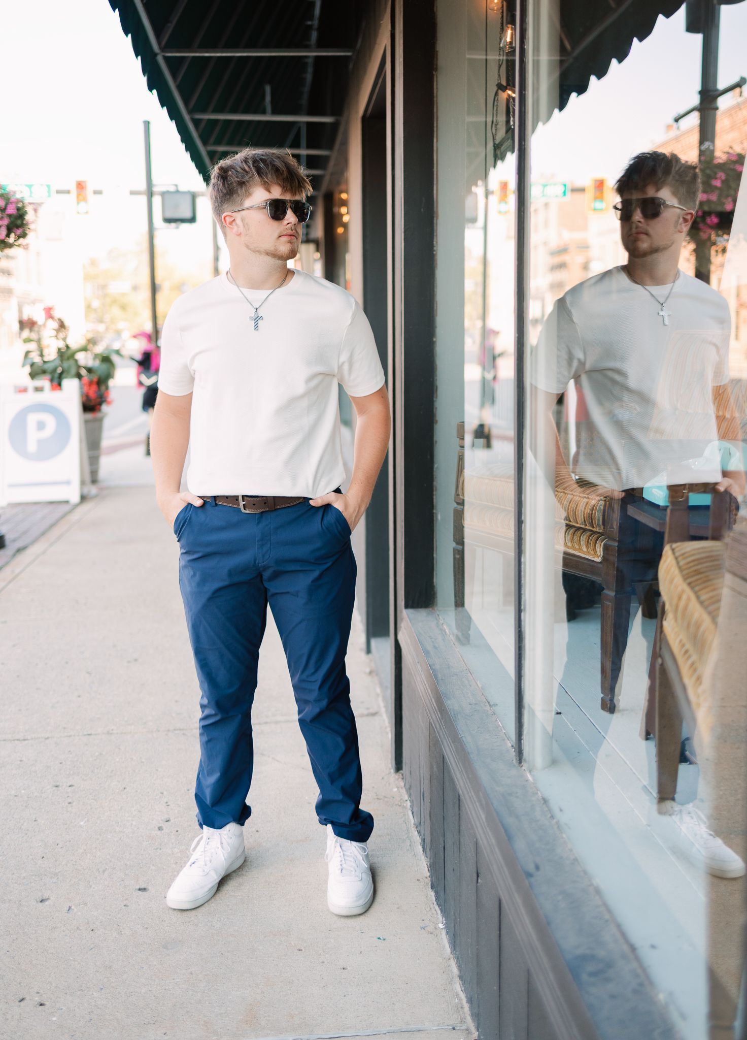 senior looking into a window shop with reflection