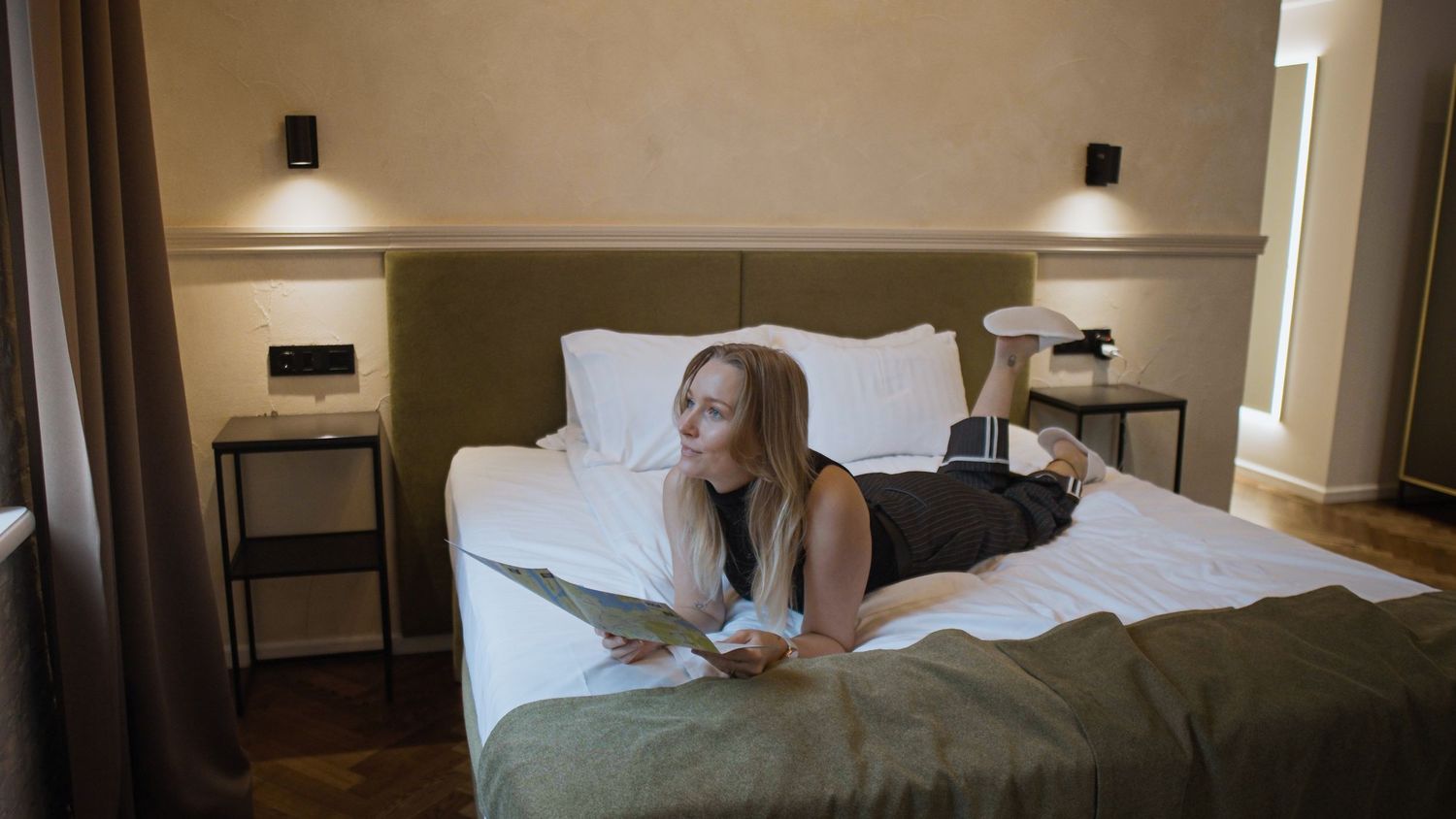 Panoramic view of a modern hotel room interior with warm lighting and minimal decor.