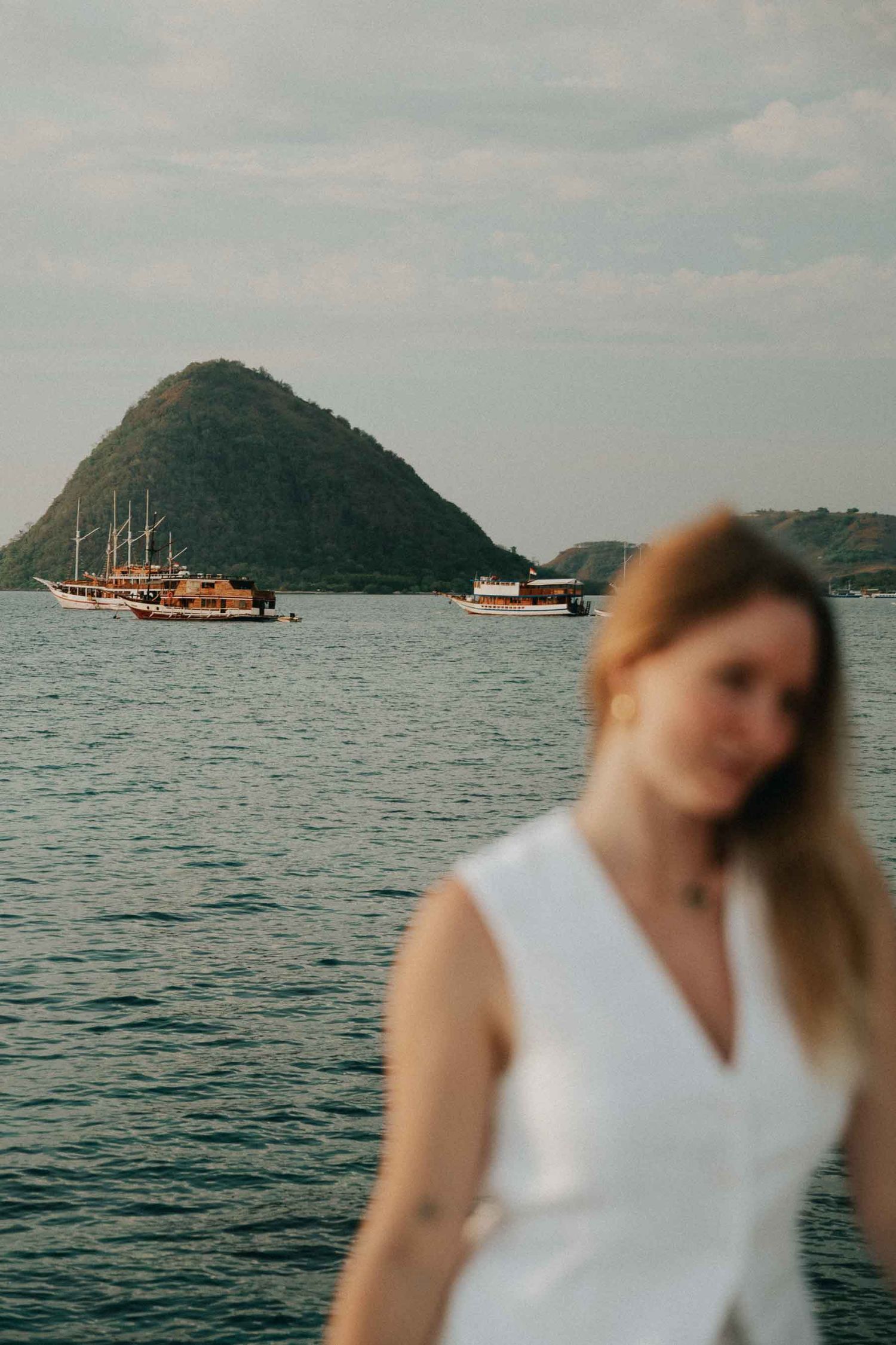 Coastal photography sequence with boats and islands visible in background.
