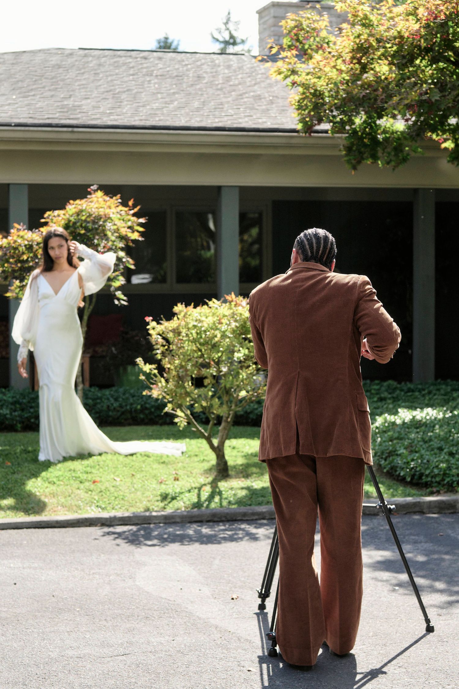 Groom taking a photo of the bride with a film camera during their wedding portraits.