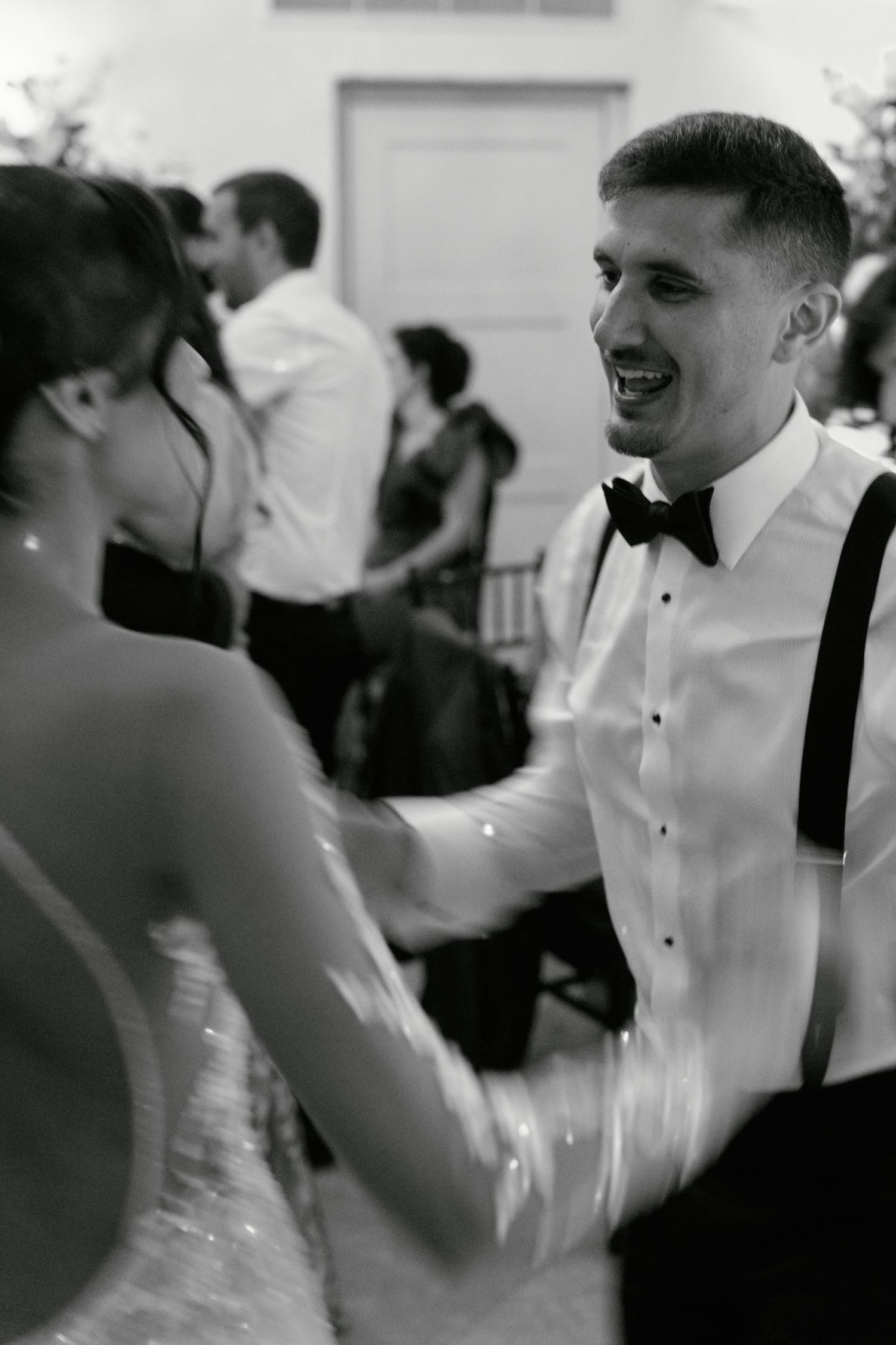 Couple shares joyful moment during wedding reception dance.