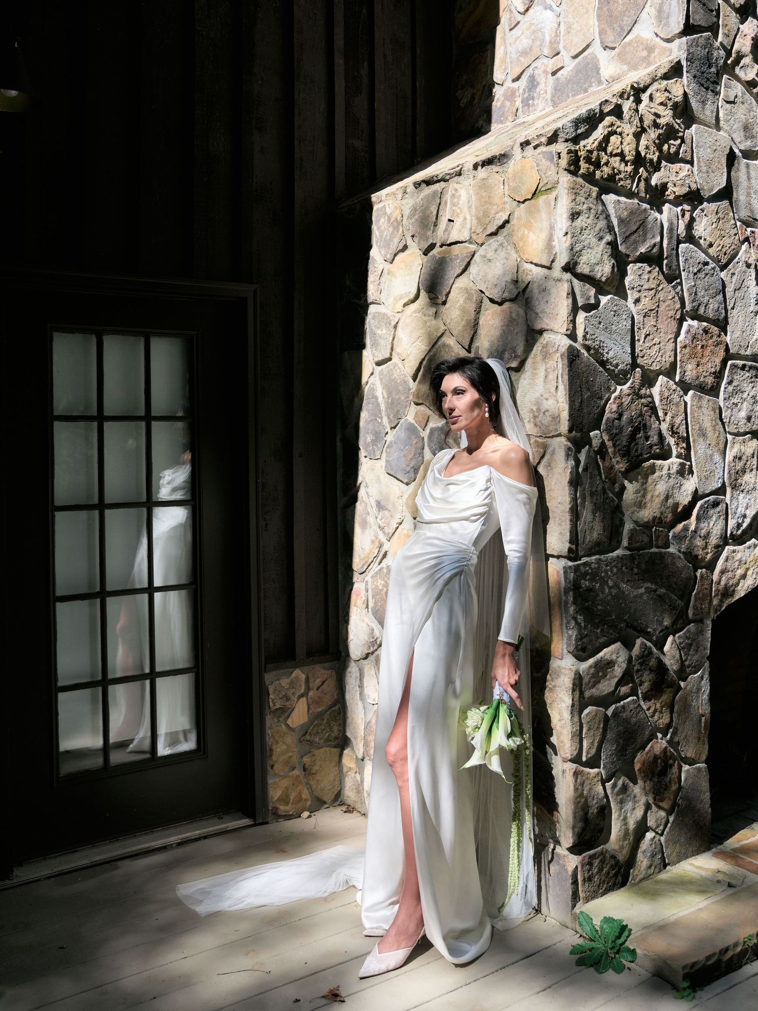 A figure in a flowing white dress poses dramatically against a stone wall in a series of artistic photographs.
