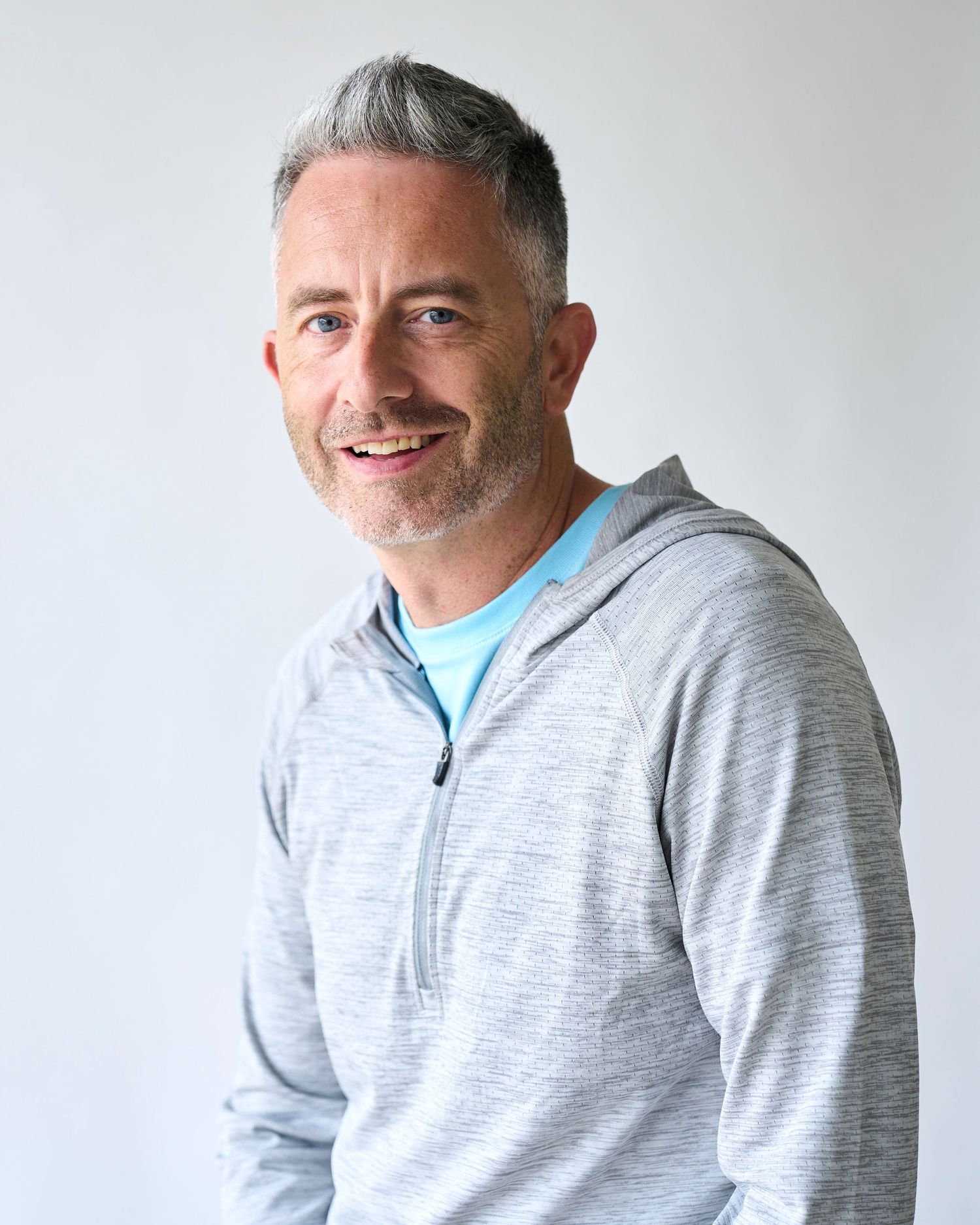 Professional headshot in Raleigh, NC of a Business owner in front of a white background.
