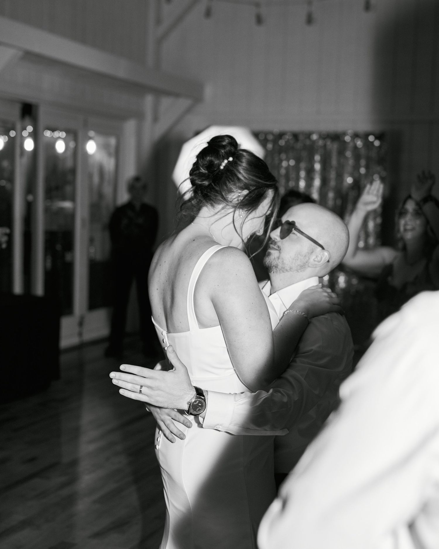 Intimate dance moment captured in black and white at an indoor wedding reception.