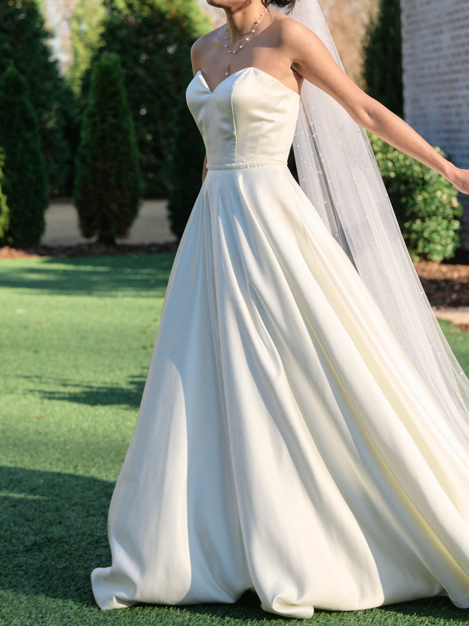 detail shot of brides dress while bride is walking