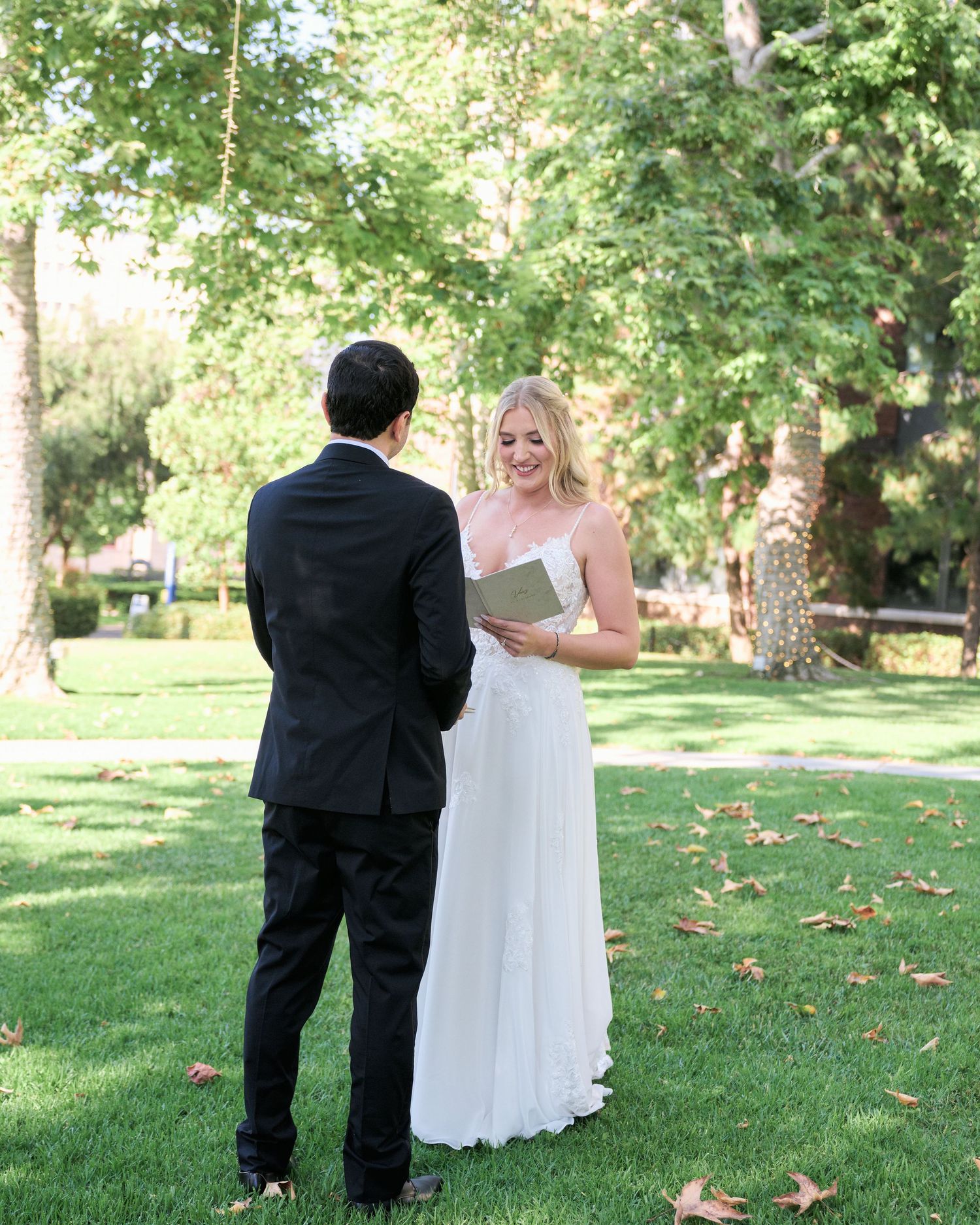A couple exchanges vows during their outdoor garden wedding ceremony.