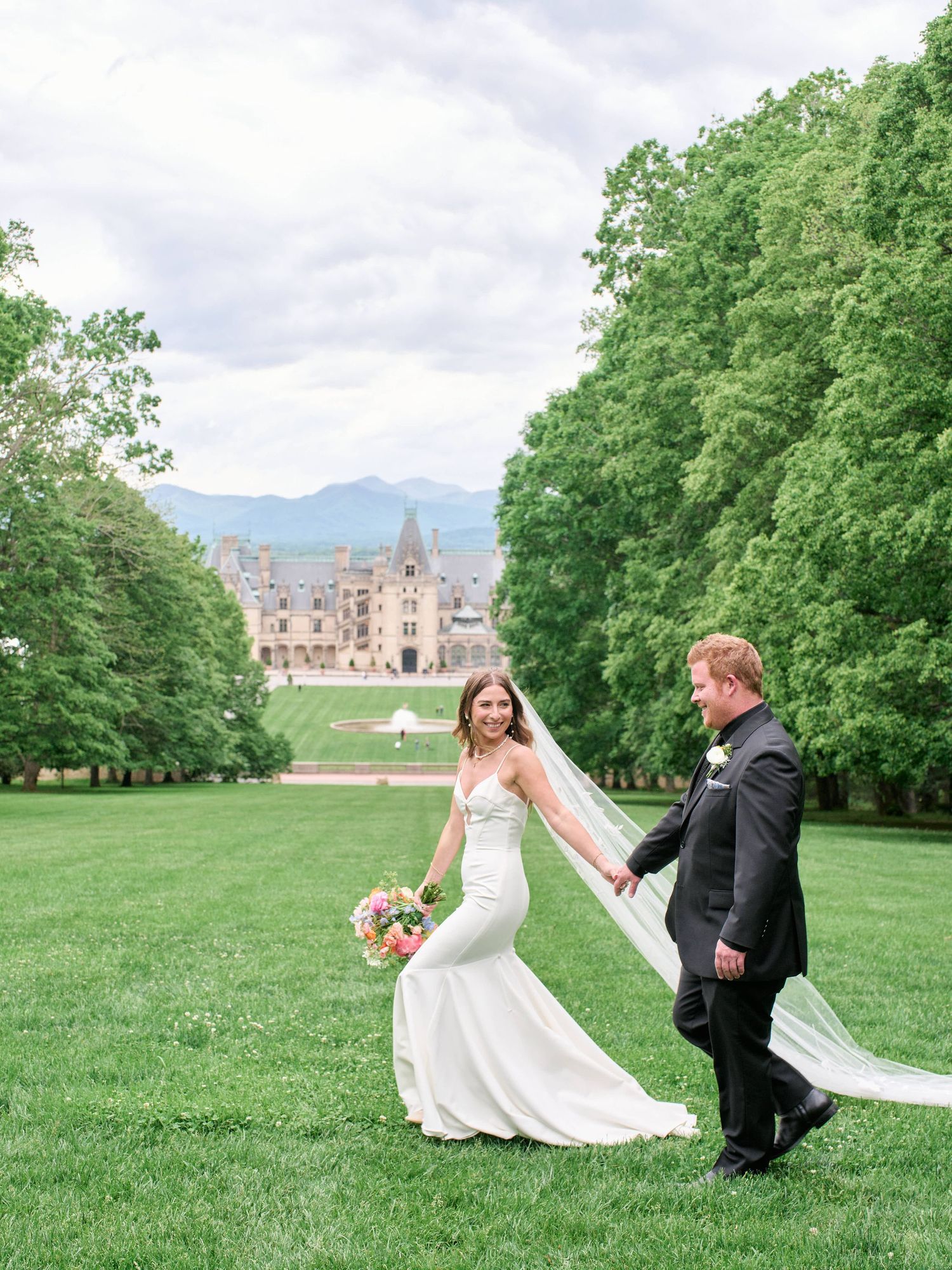 A couple in wedding attire poses playfully across a series of photos on a grand estate's lush green lawn.