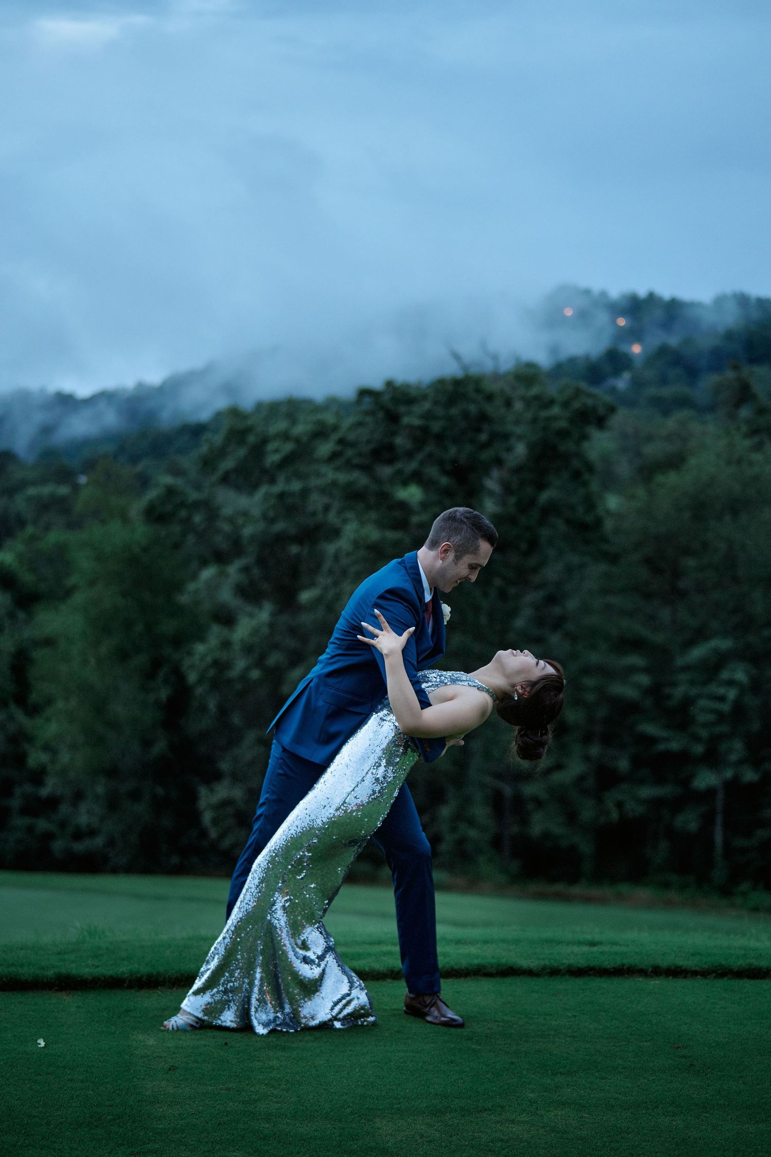A romantic dip dance pose captured at dusk on a golf course.