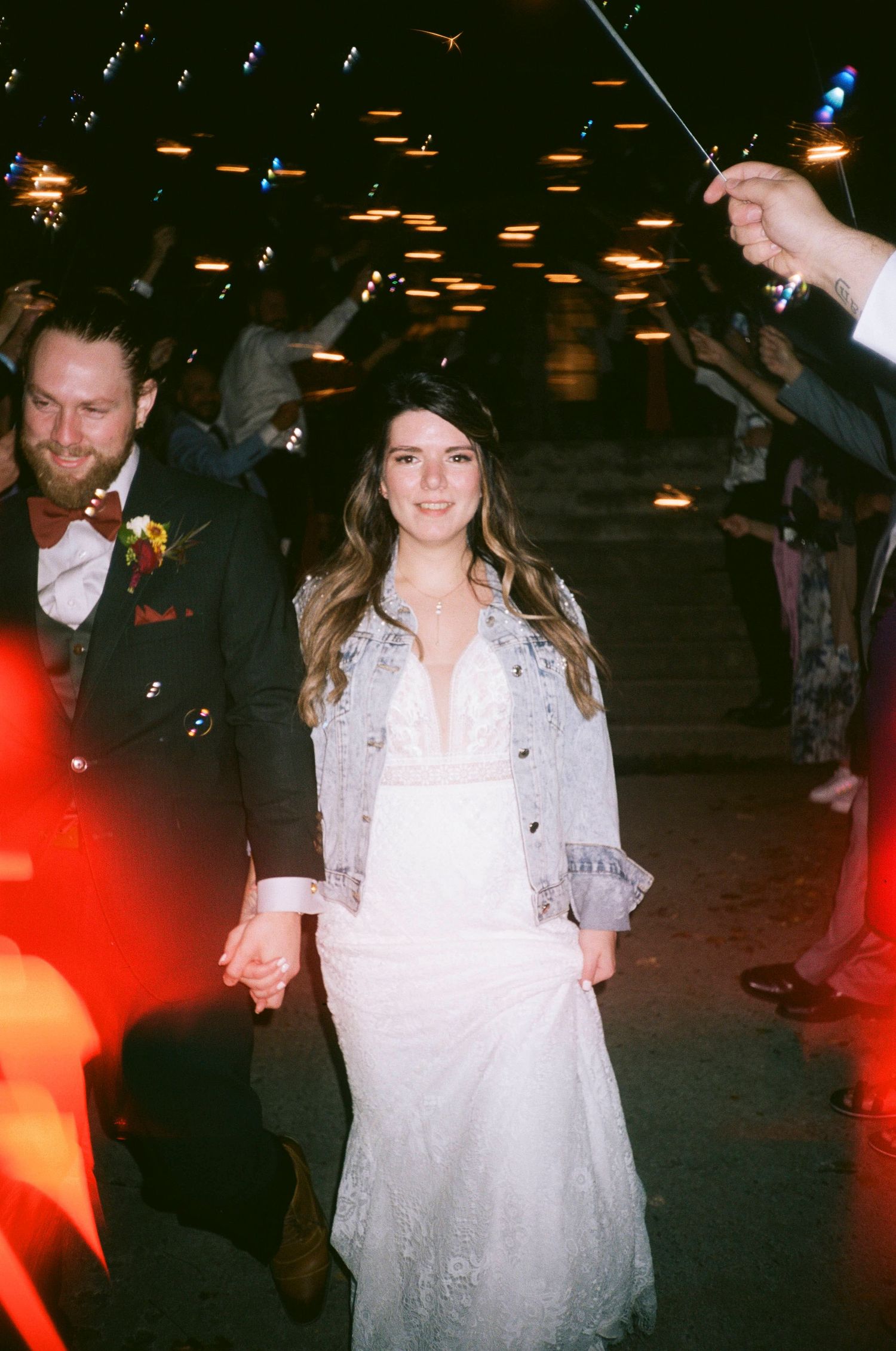 A wedding celebration scene with sparklers and festive lighting creating a magical atmosphere.