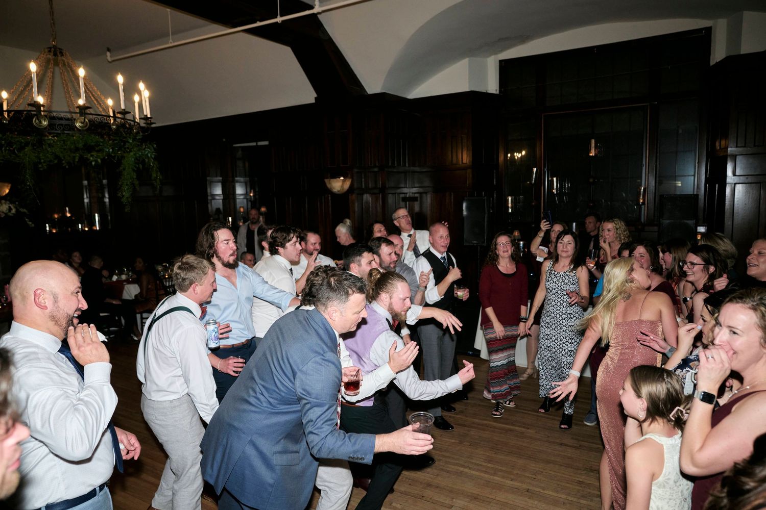 Wedding guests react emotionally during a reception celebration.
