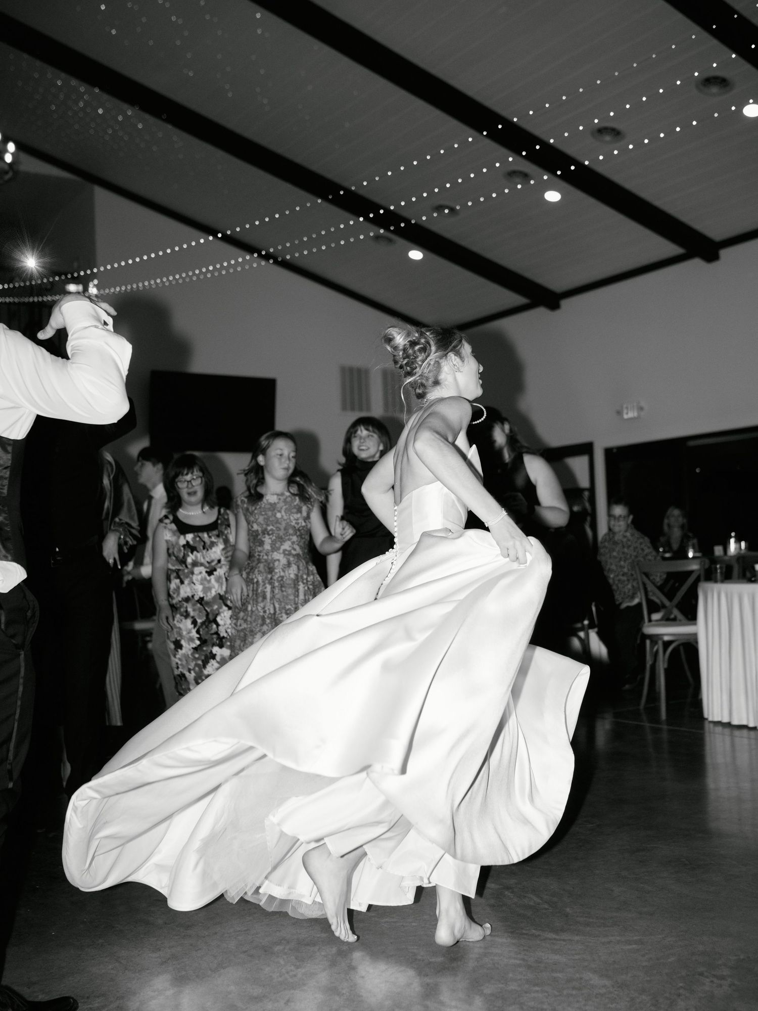 Black and white photos show dancers spinning and twirling on a dance floor during a celebration event.