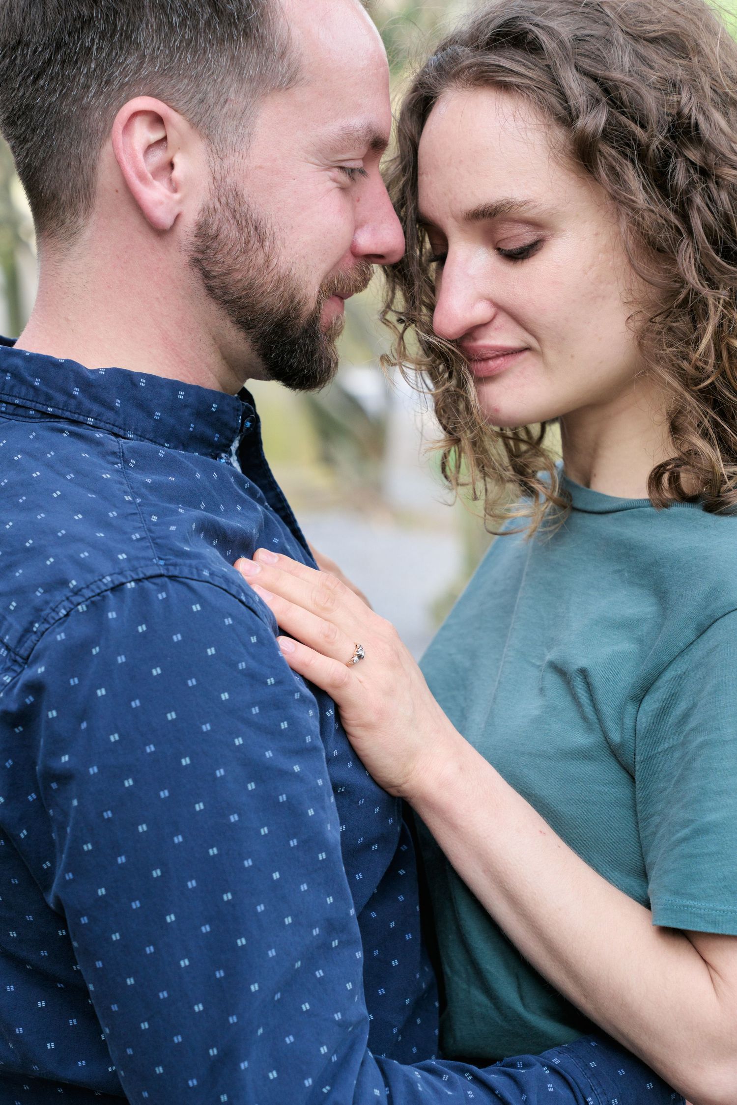 Close-up of romantic couple sharing an intimate moment outdoors.