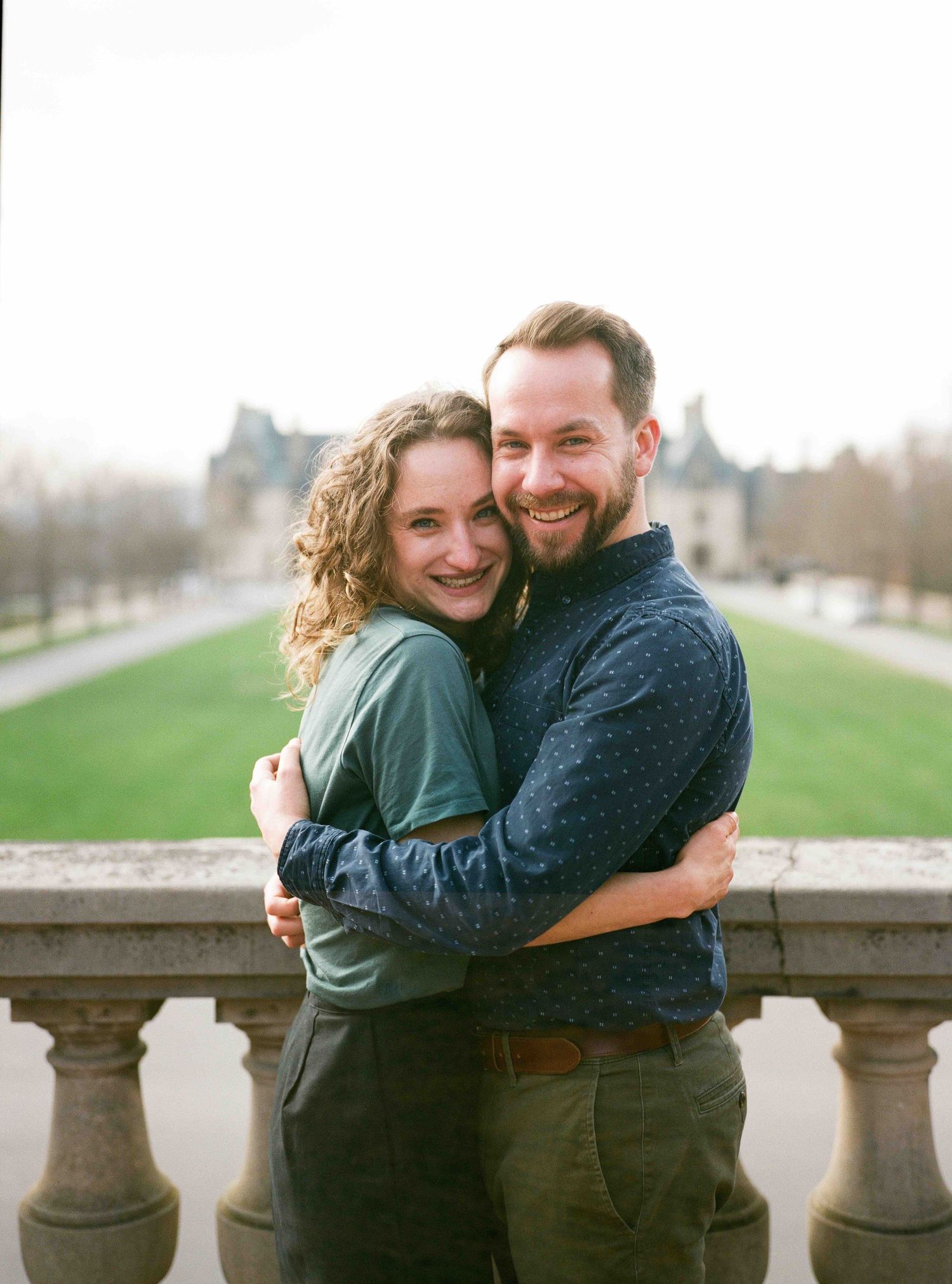 Portrait photos a couple standing in front of the Biltmore Estate engagement photos.