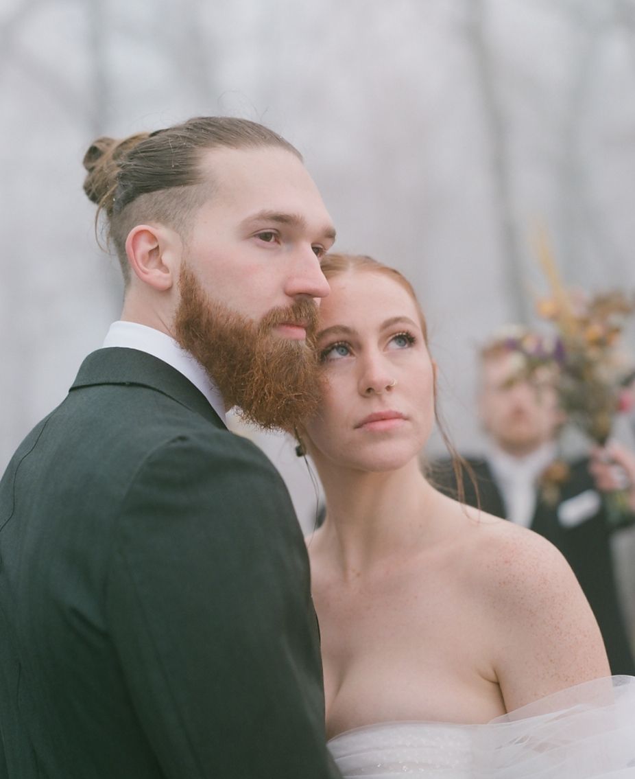 A stylish winter wedding portrait with moody atmospheric lighting.