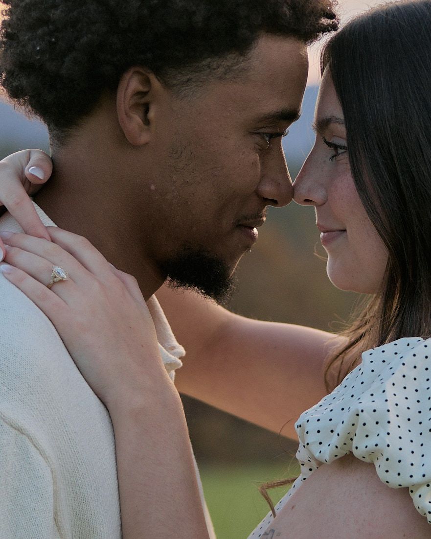 A couple shares a tender romantic moment outdoors in a series of intimate close-up shots.