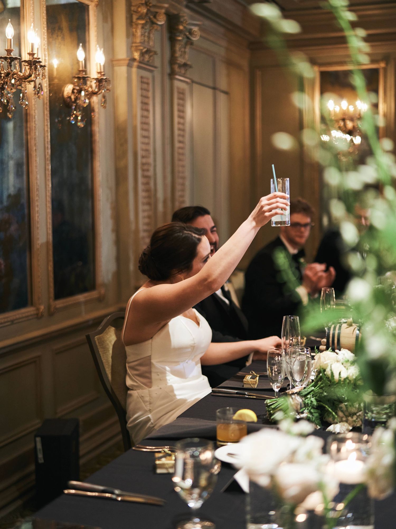 A series of candid dining photos showing guests raising glasses in celebration at an elegant restaurant setting.