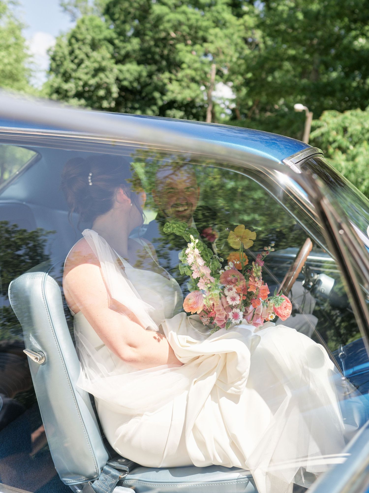 A series of four photos showing someone in a light-colored dress reclining across the front seats of a car.