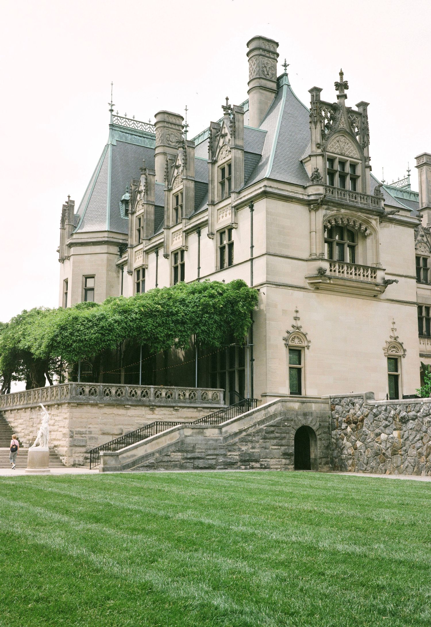 Majestic stone mansion with Gothic architecture and manicured grounds.