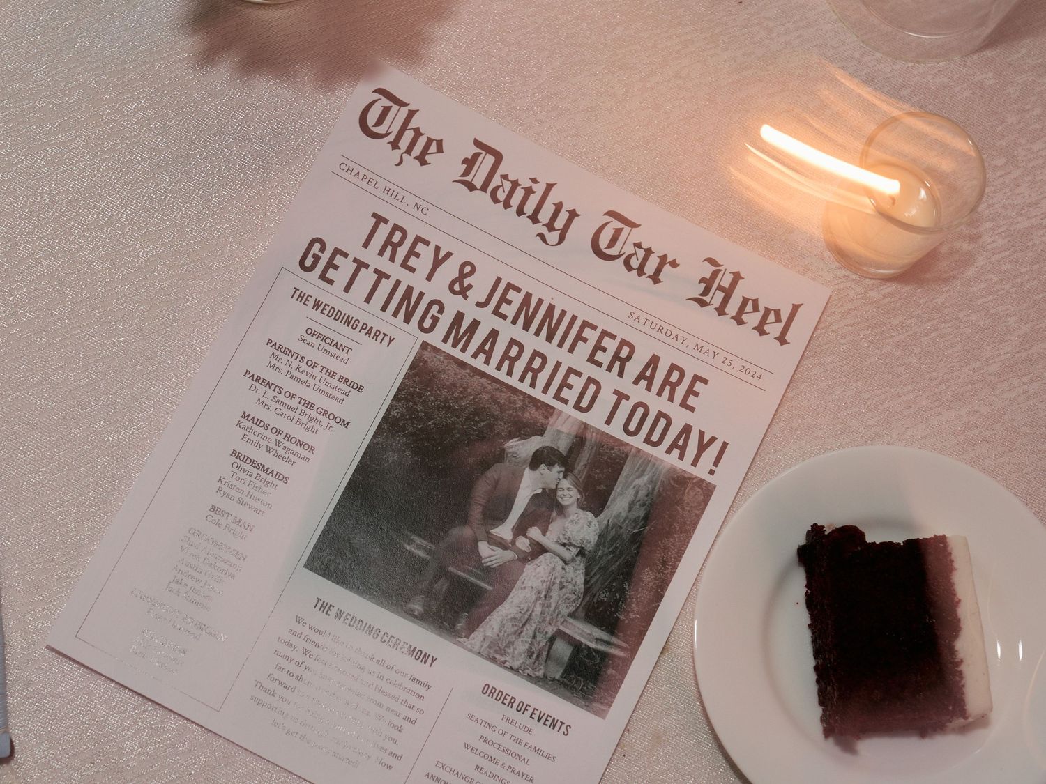 A wedding announcement in The Daily Tar Heel newspaper sits on a table with ambient lighting.
