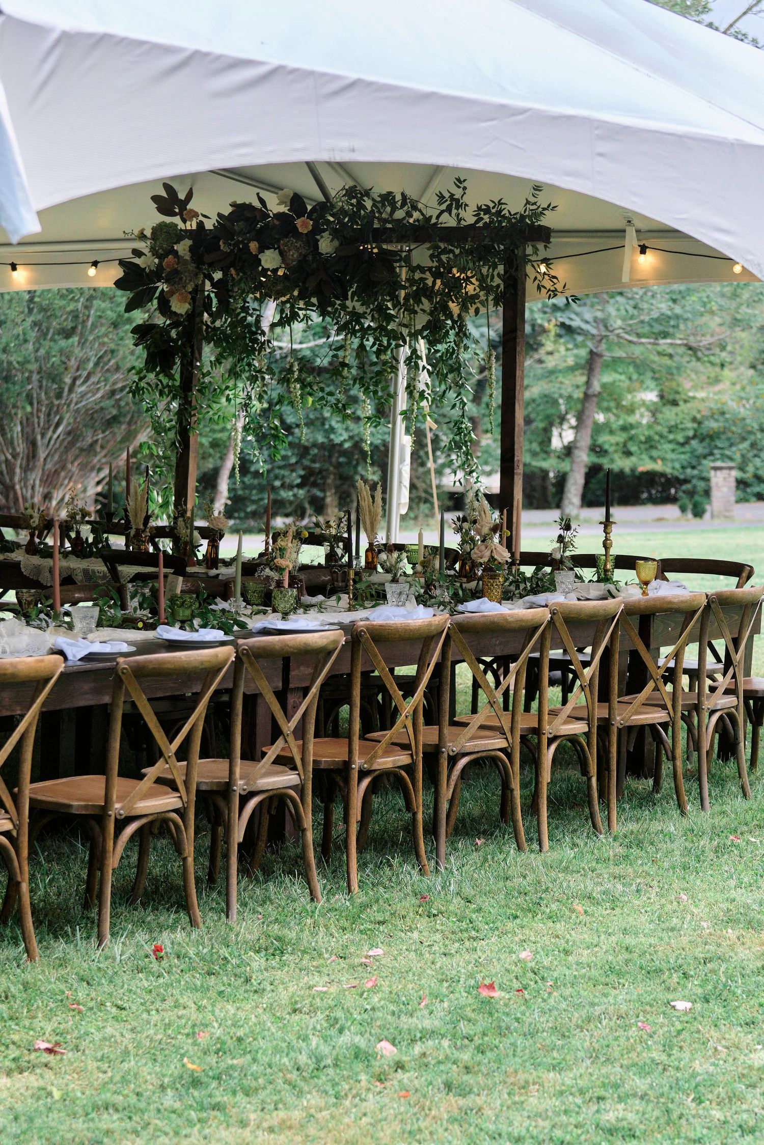 details of tables and chairs of an outdoor alfresco style wedding.