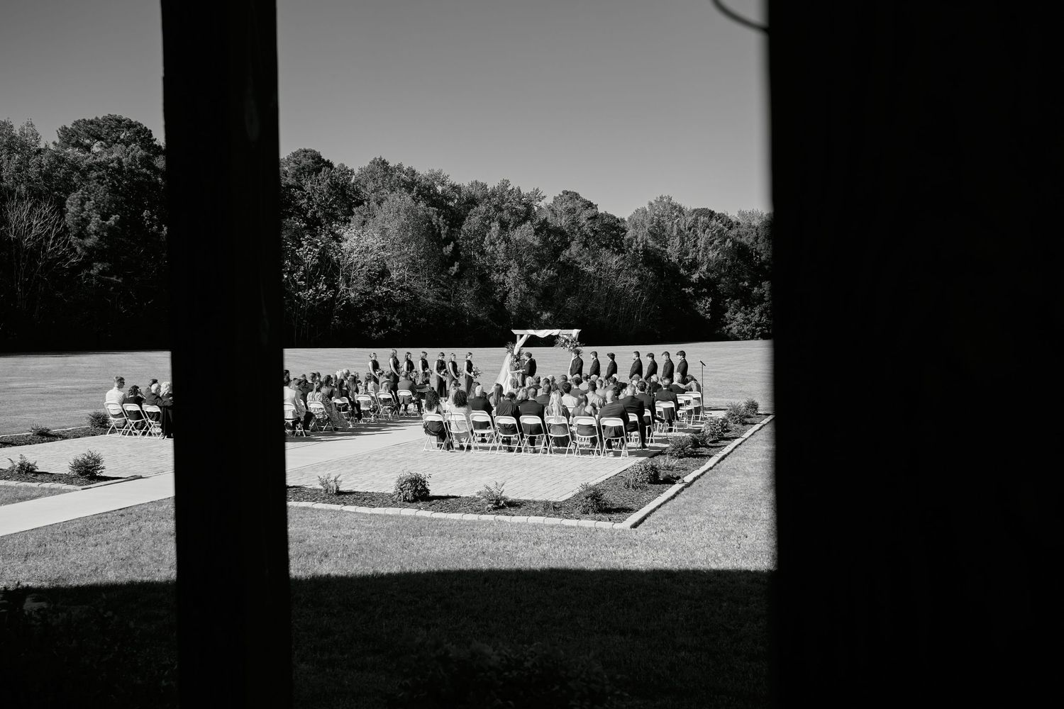 A black and white panoramic view of military personnel standing in formation on a field.