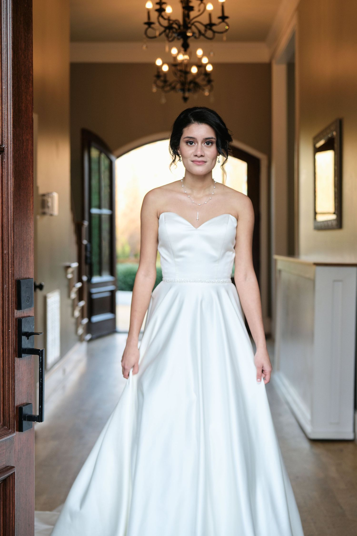 Bride standing next to the door before the ceremony at The Bradford Raleigh