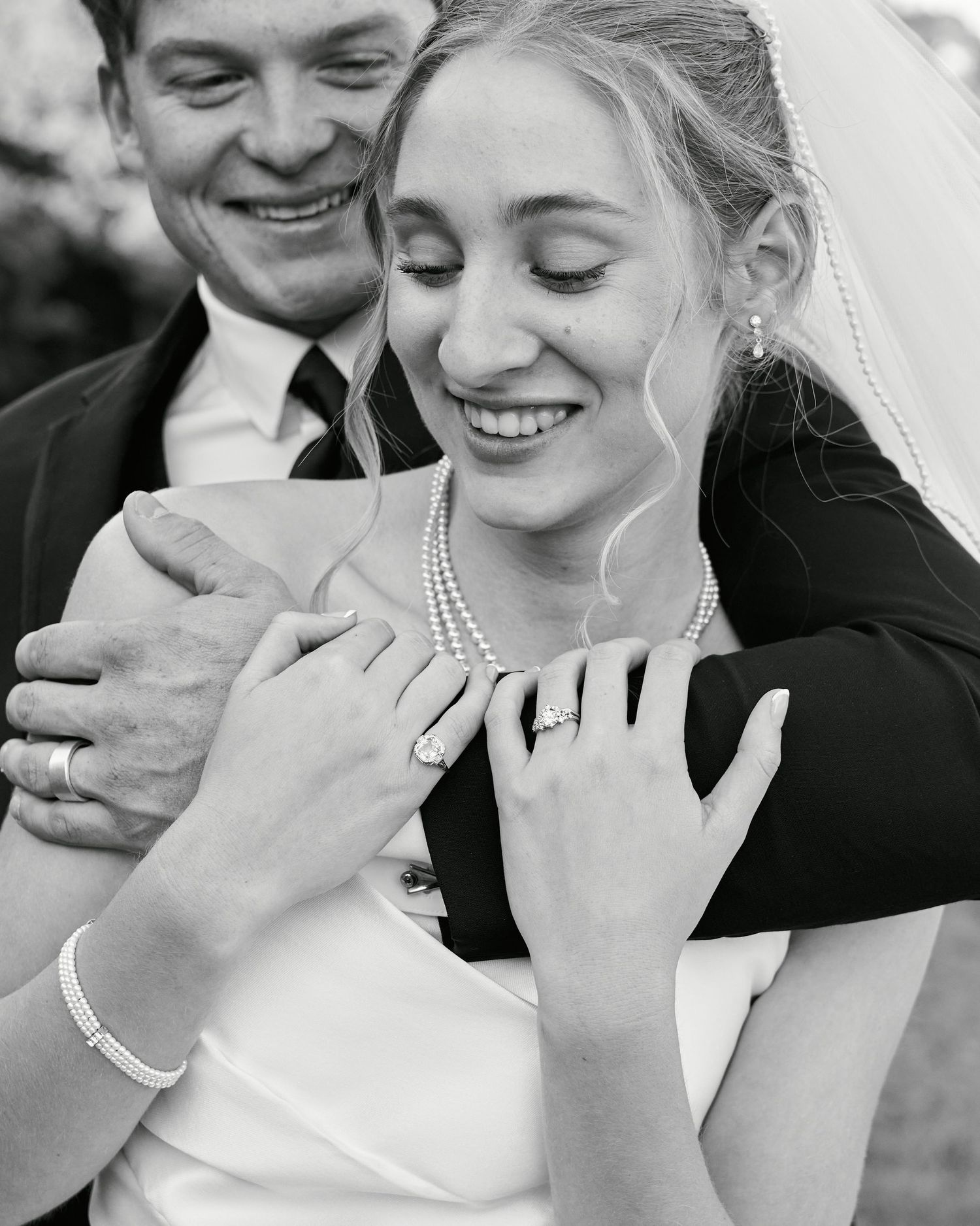 Black and white wedding photo series showing romantic close-up moments between newlyweds sharing tender embraces.