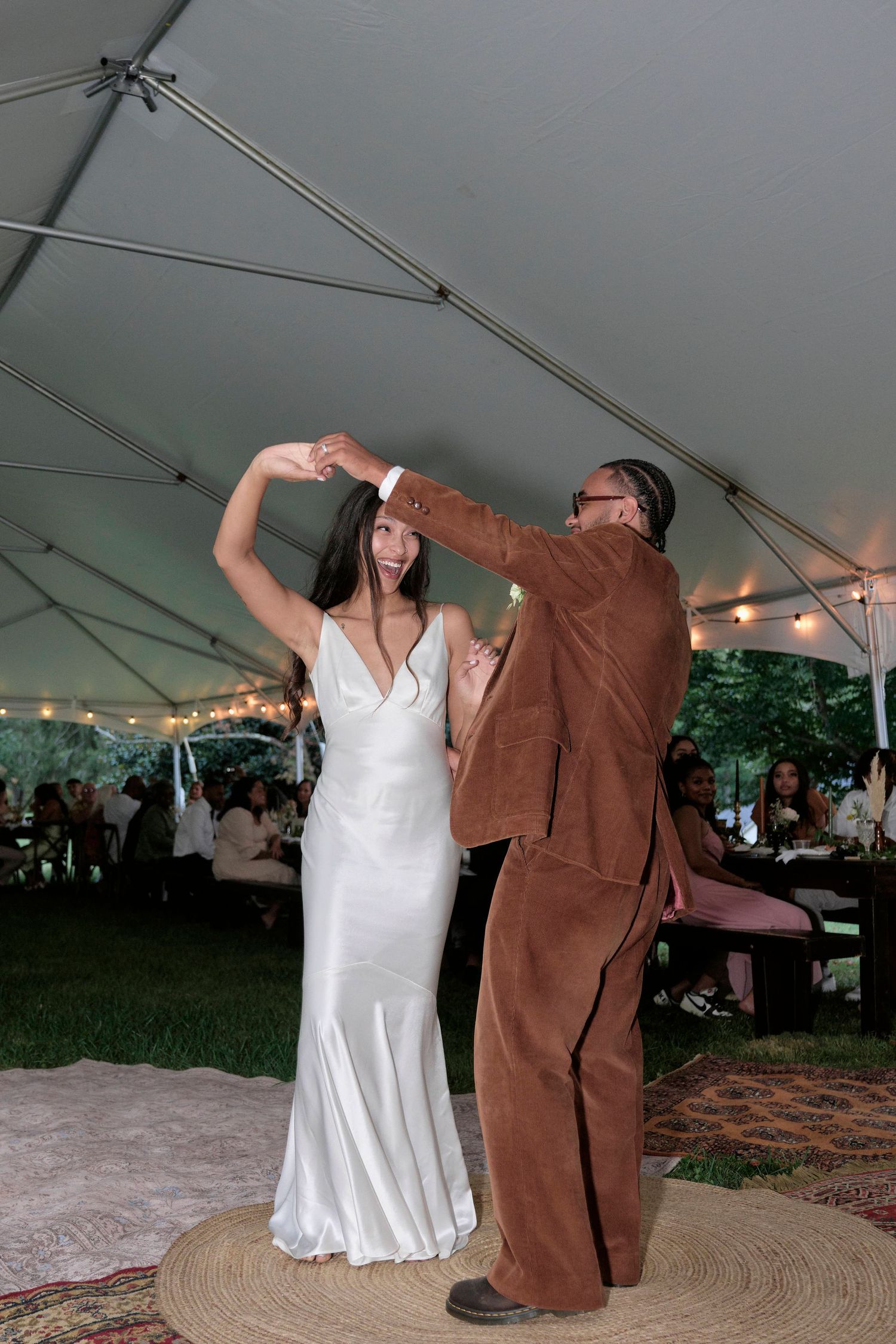 Bride and groom dancing under their tent style wedding.