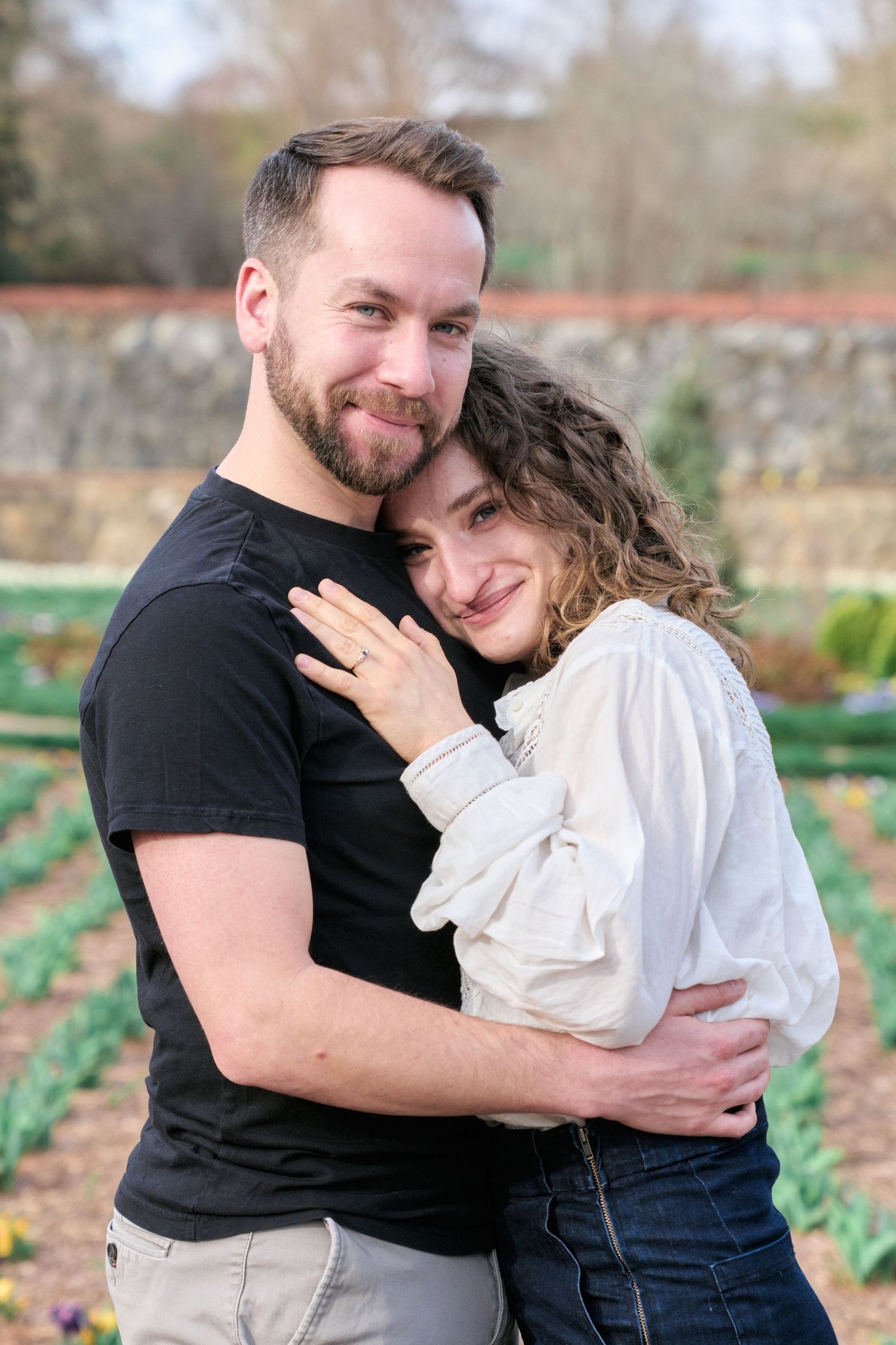Portrait of a couple looking at the camera standing on the Biltmore gardens during their engagement photos a