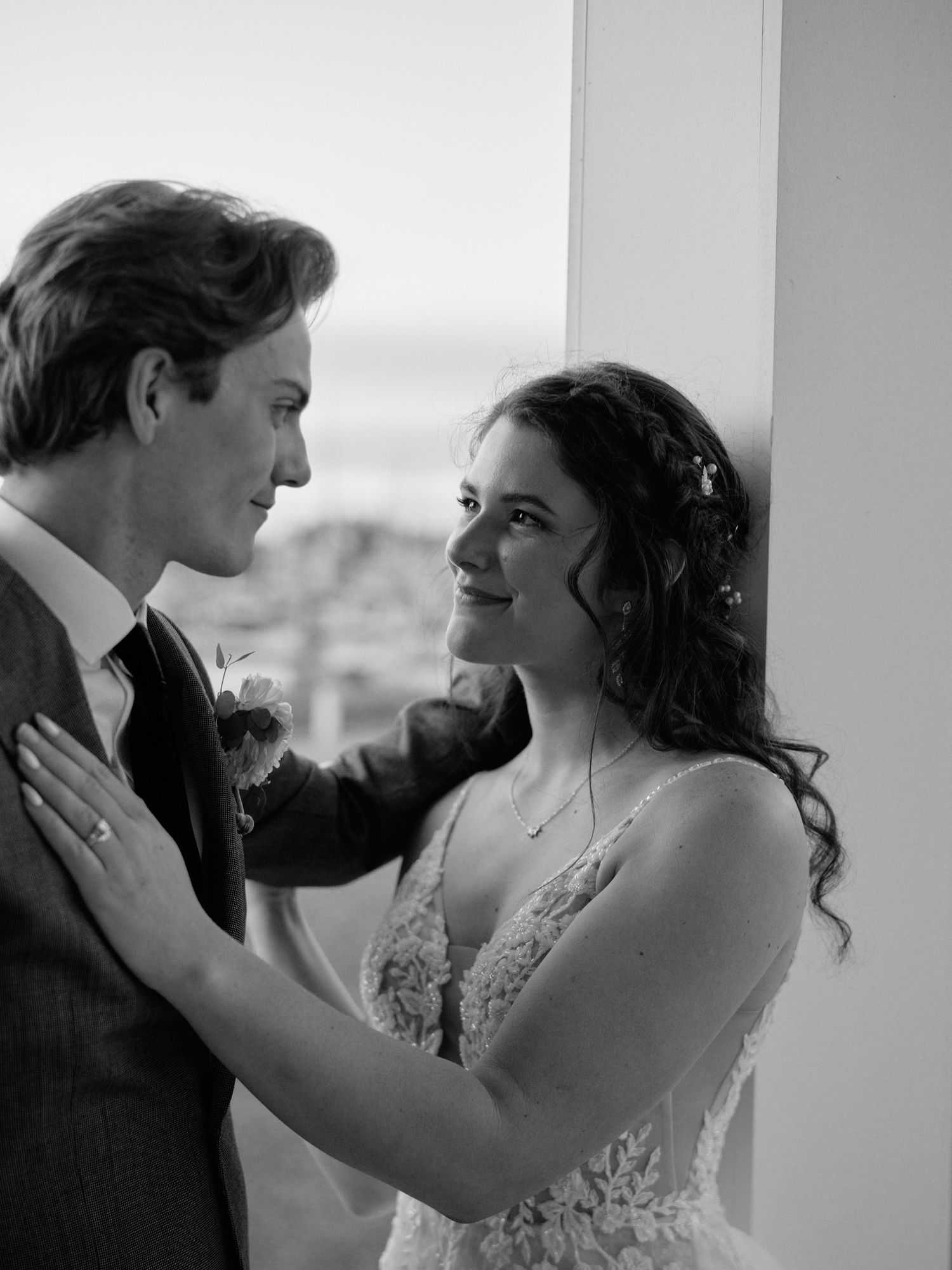 A romantic black and white wedding photo of a couple sharing an intimate moment together.