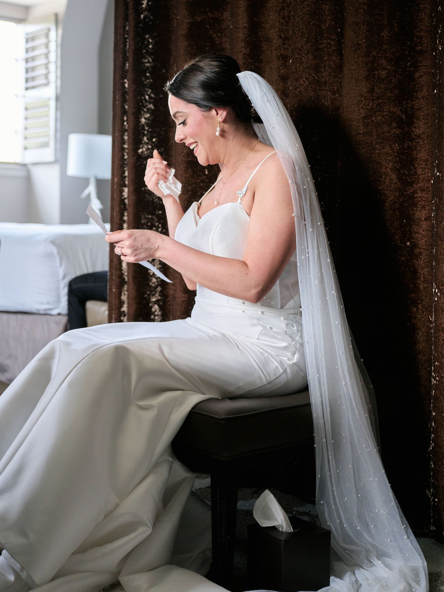 An emotional moment during wedding preparations in an elegant room.