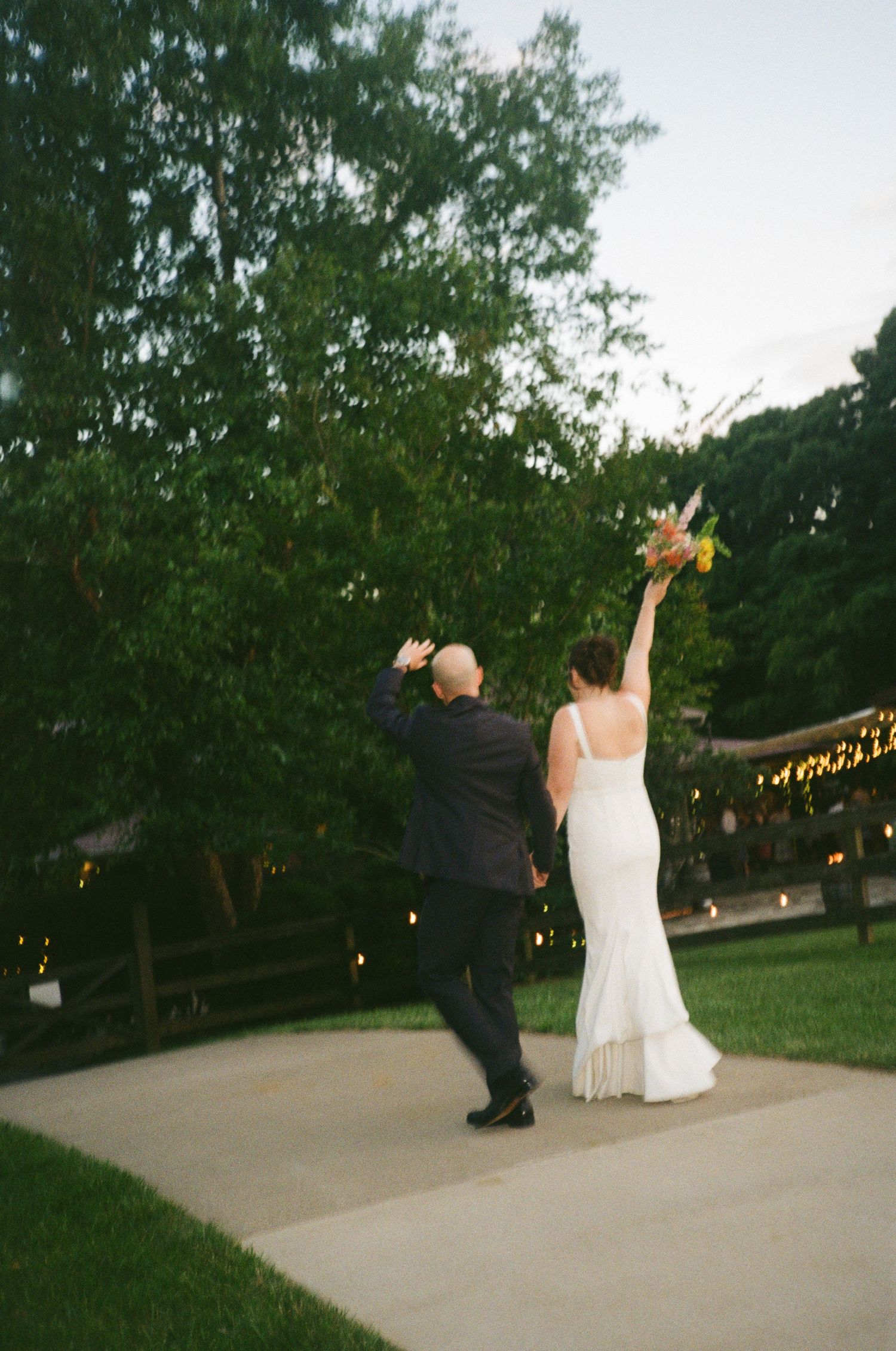 Artistic motion blur capture of newlyweds embracing on a green lawn.