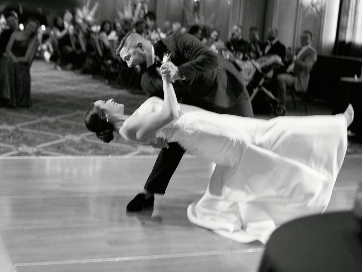 Dramatic black and white dance dip during wedding reception.