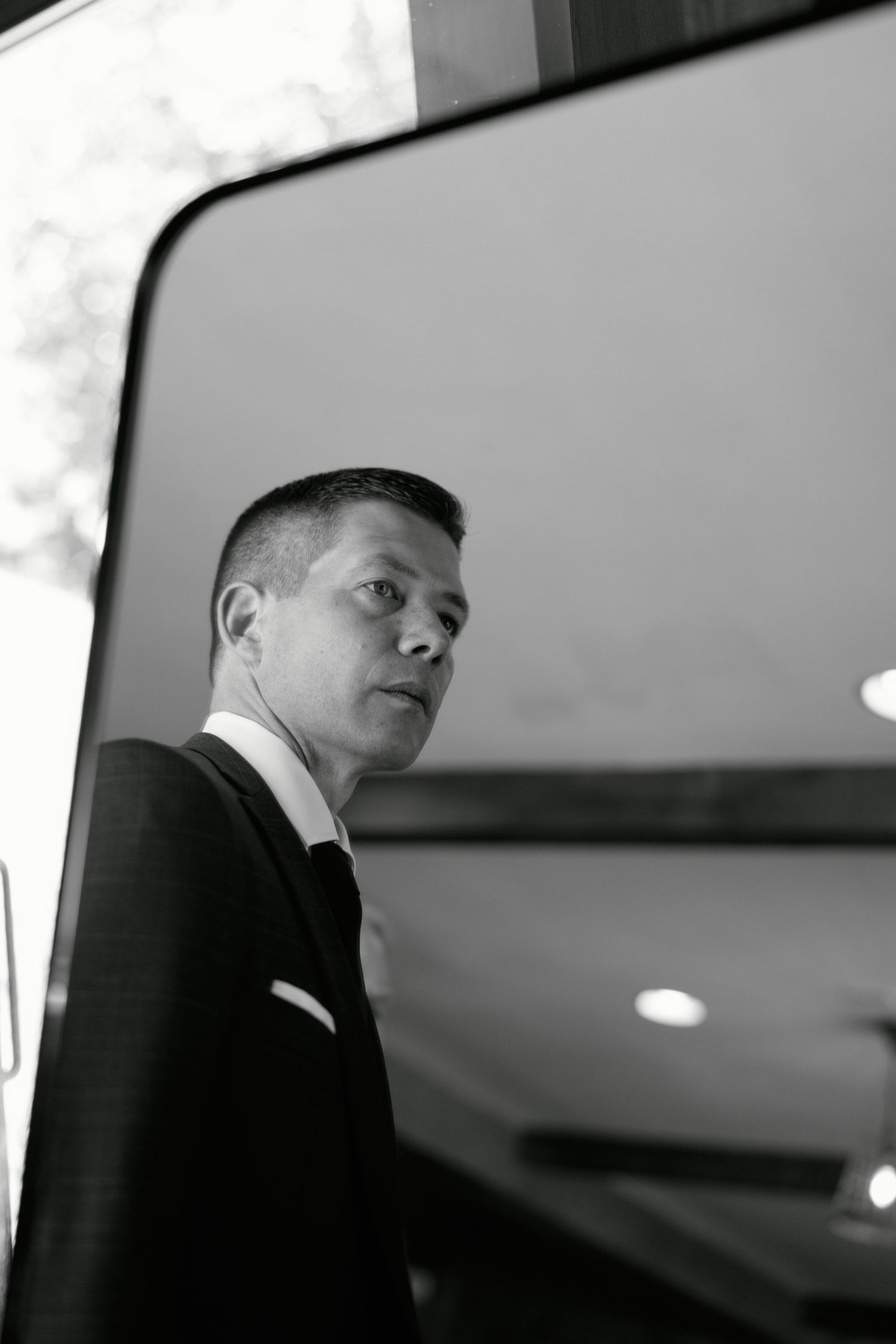 Black and white portrait of a person in formal attire looking to the side.
