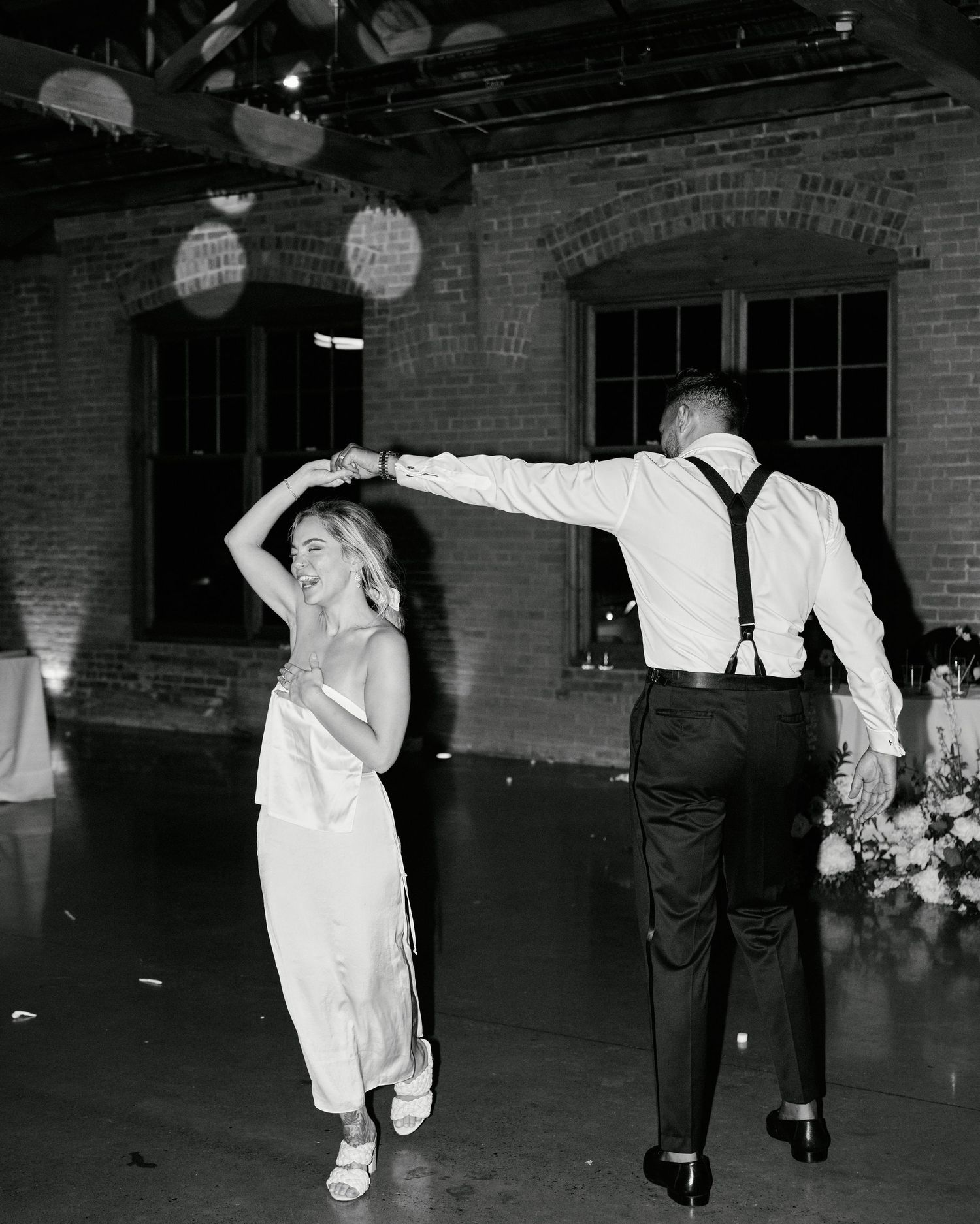 A bride and groom dance together at their wedding reception.